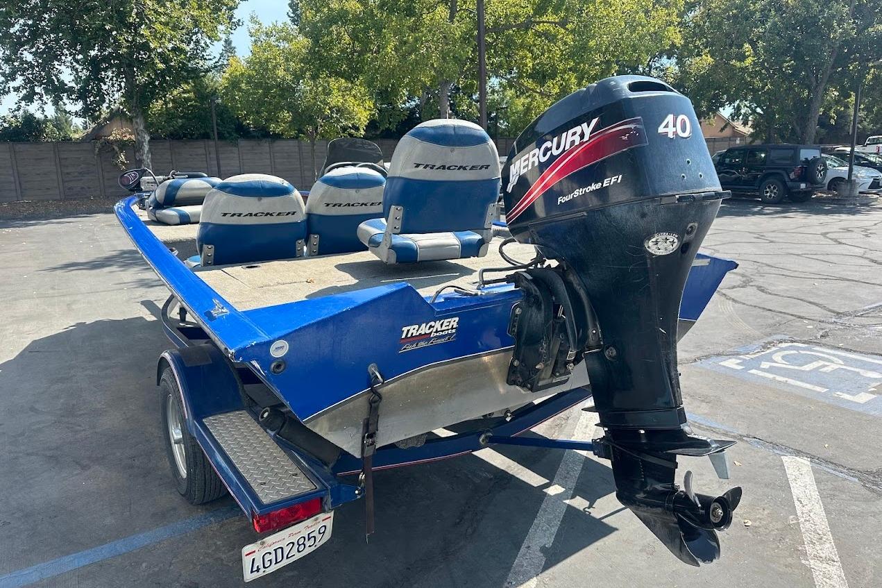 2005 Bass Tracker Pro Team 175 boat with Mercury 40 outboard motor in parking lot.