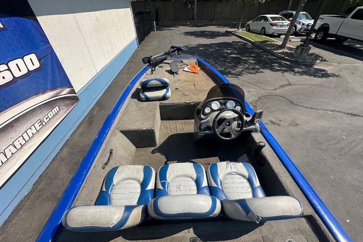 2005 Bass Tracker Pro Team 175 boat interior with blue and gray seating and steering console.
