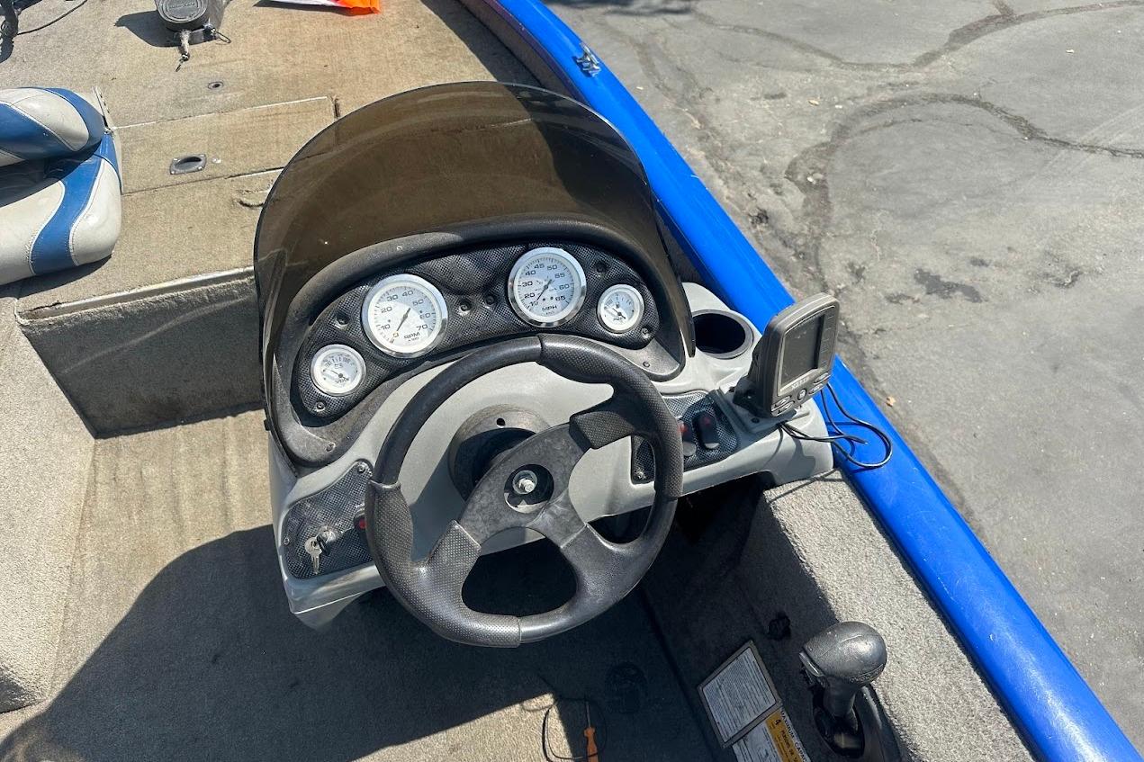 2005 Bass Tracker Pro Team 175 boat dashboard with steering wheel and gauges.