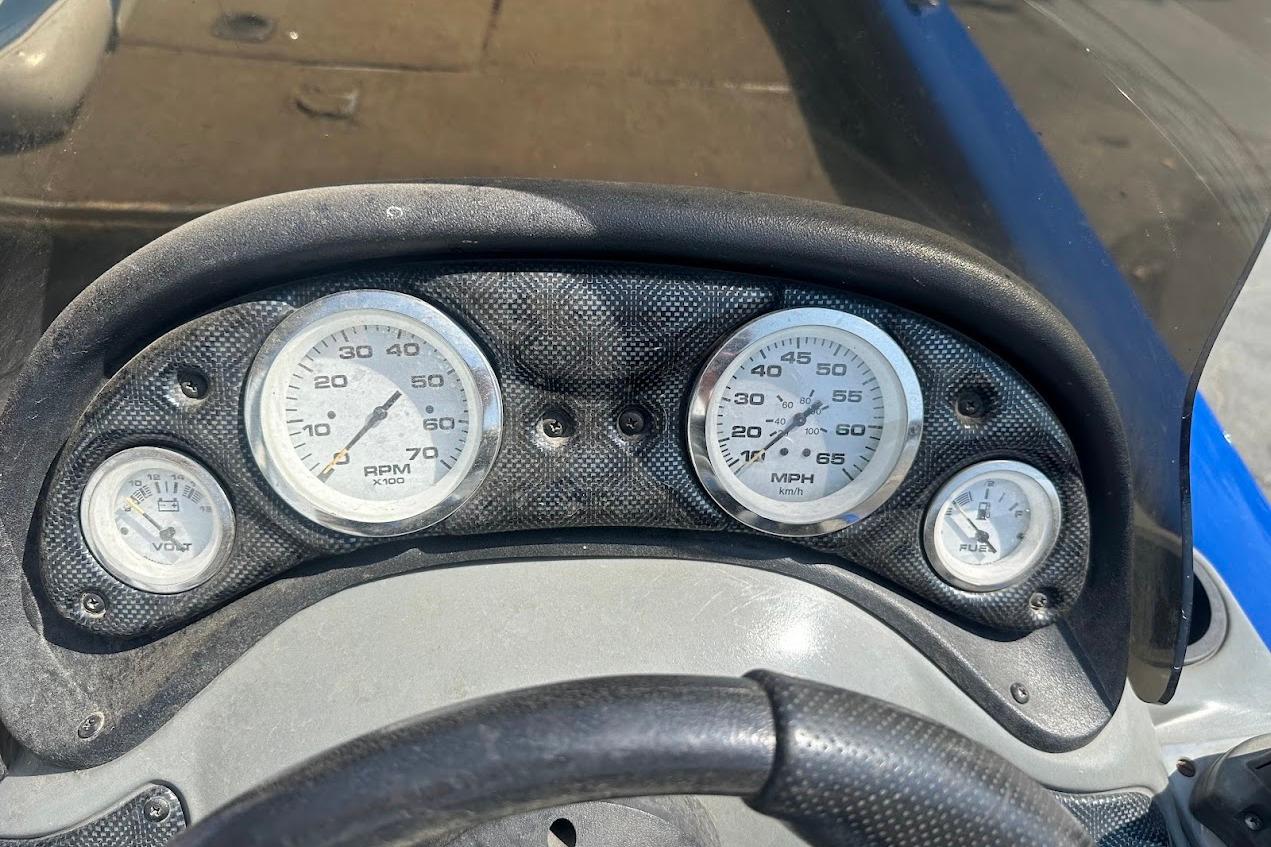 Dashboard of a 2005 Bass Tracker Pro Team 175 boat with gauges for RPM, speed, and fuel.