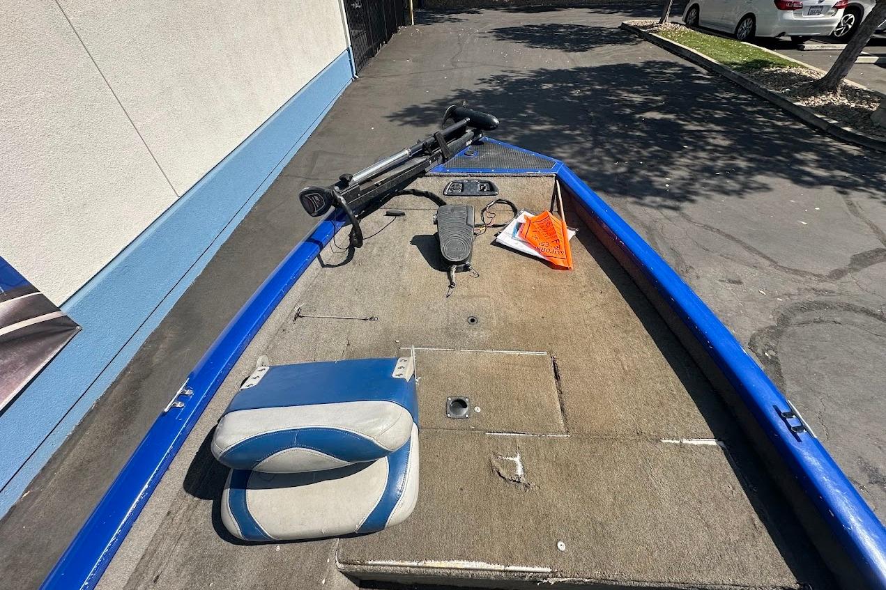 2005 Bass Tracker Pro Team 175 boat interior with blue accents and fishing equipment.