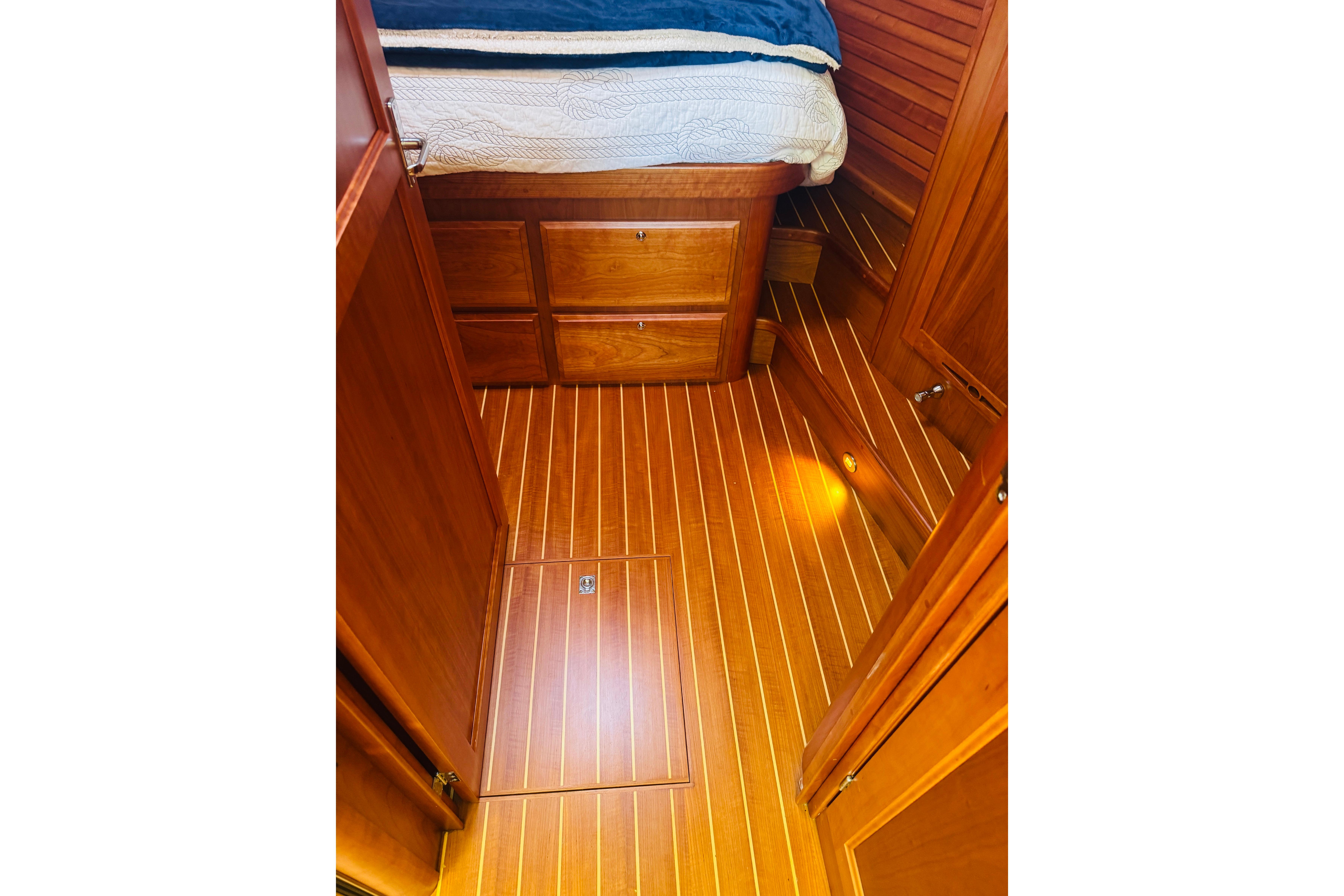 2015 Sabre 38 Salon Express interior with wooden flooring and built-in storage.