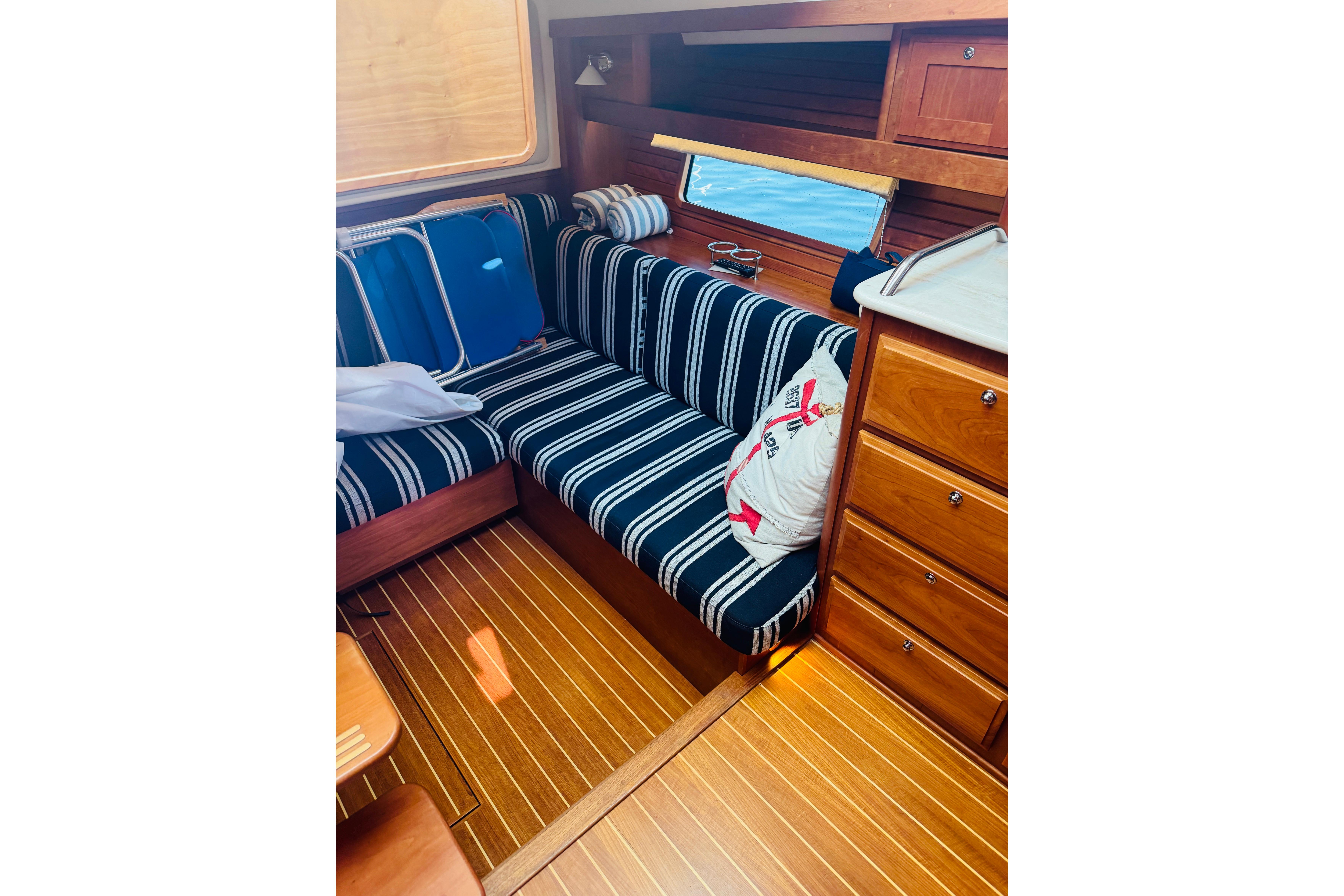Interior of 2015 Sabre 38 Salon Express with striped seating and wooden cabinetry.