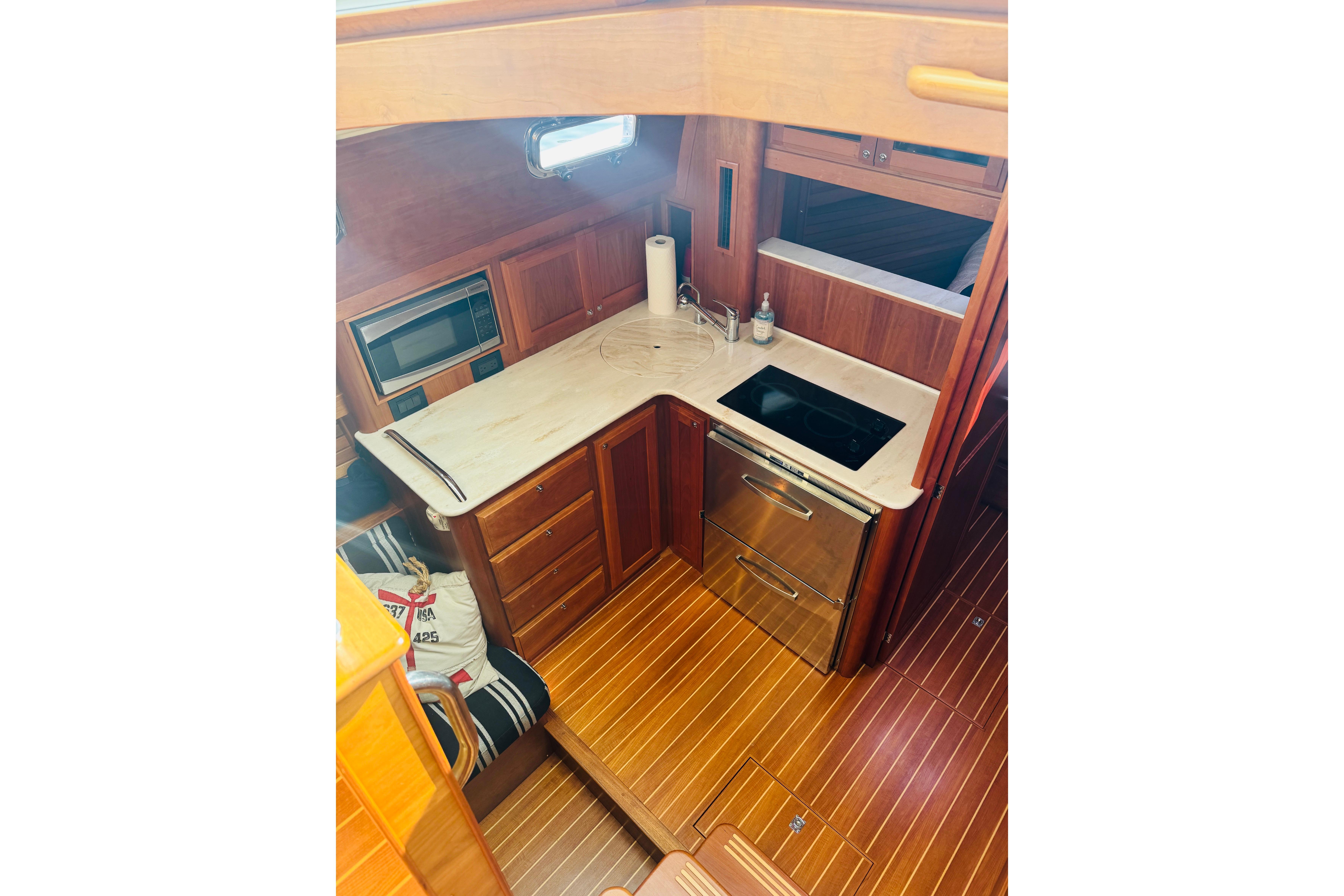 Interior of 2015 Sabre 38 Salon Express yacht, featuring a modern kitchen with wood cabinetry.