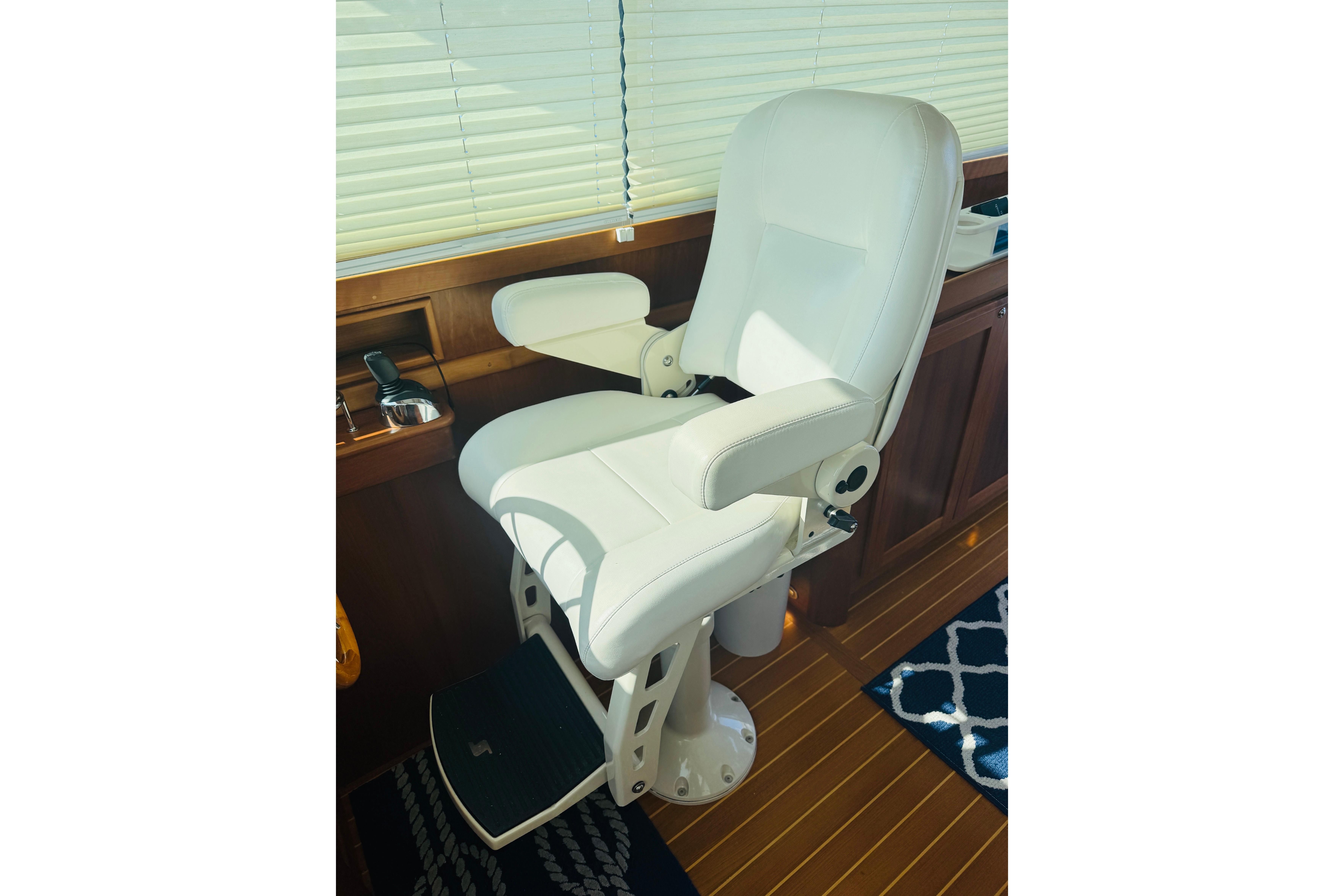 Captainu0027s chair in 2015 Sabre 38 Salon Express, featuring white upholstery and wooden interior.