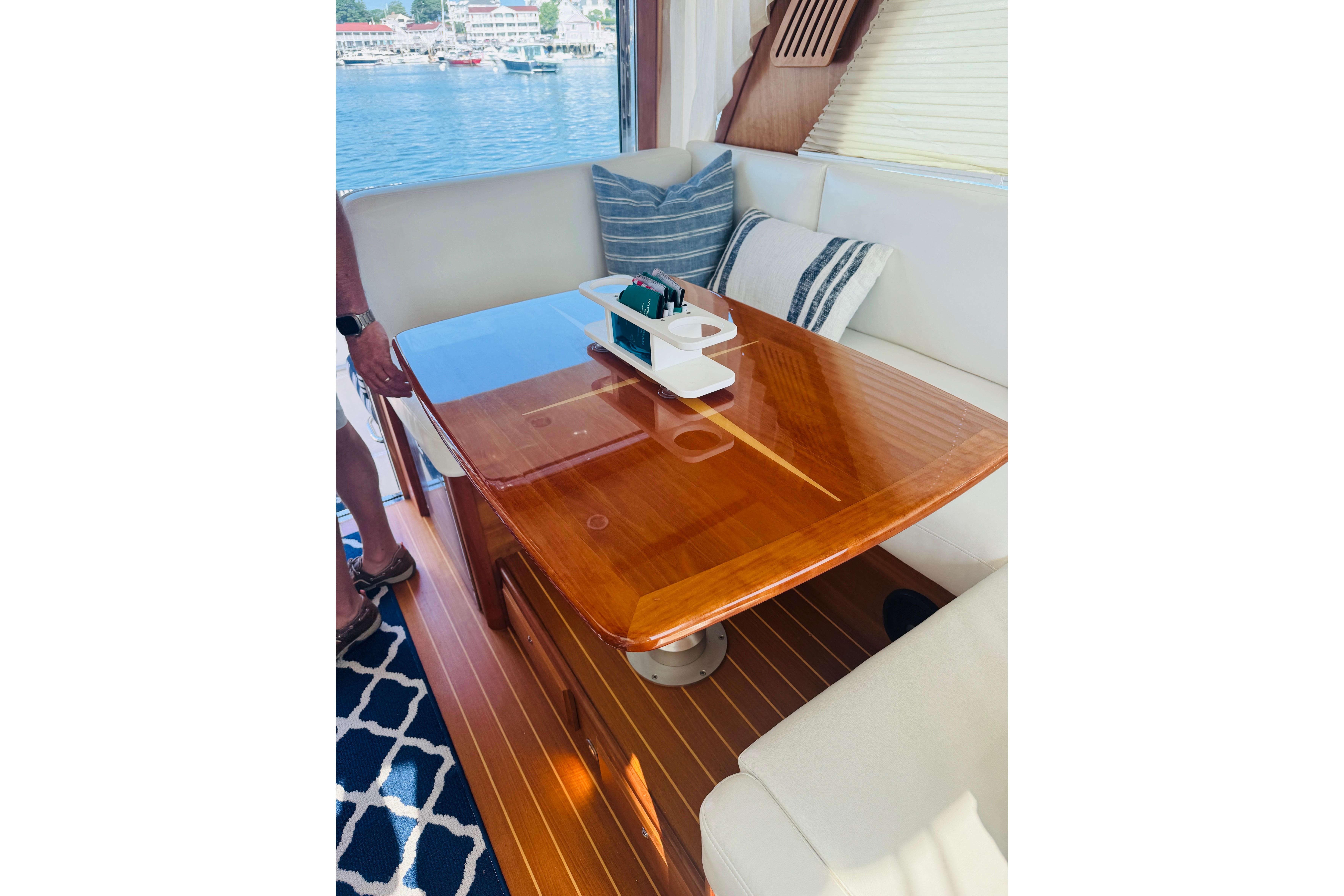 Luxurious interior of 2015 Sabre 38 Salon Express with polished wood table and comfortable seating.