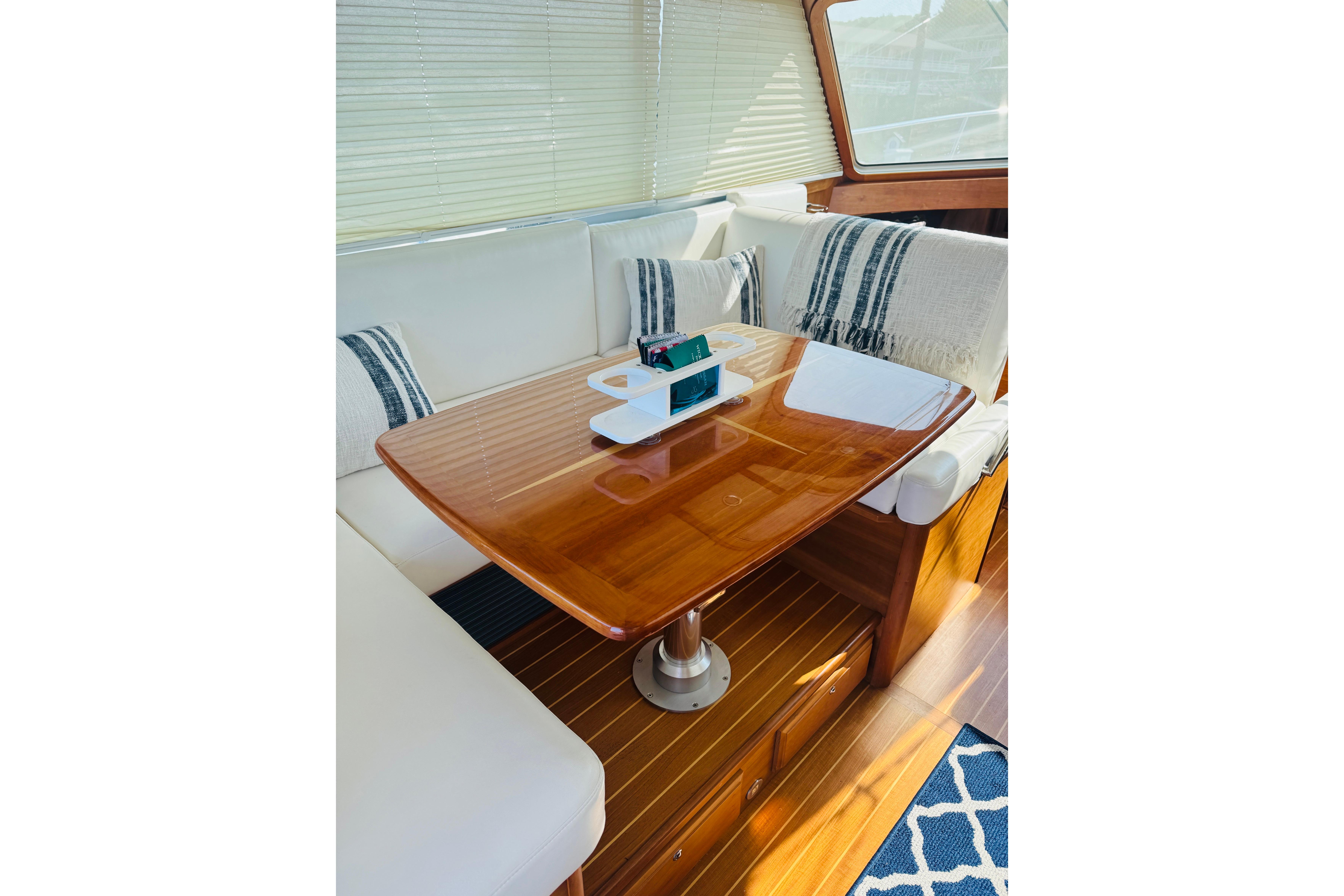 Luxurious interior of 2015 Sabre 38 Salon Express with elegant wood table and plush seating.