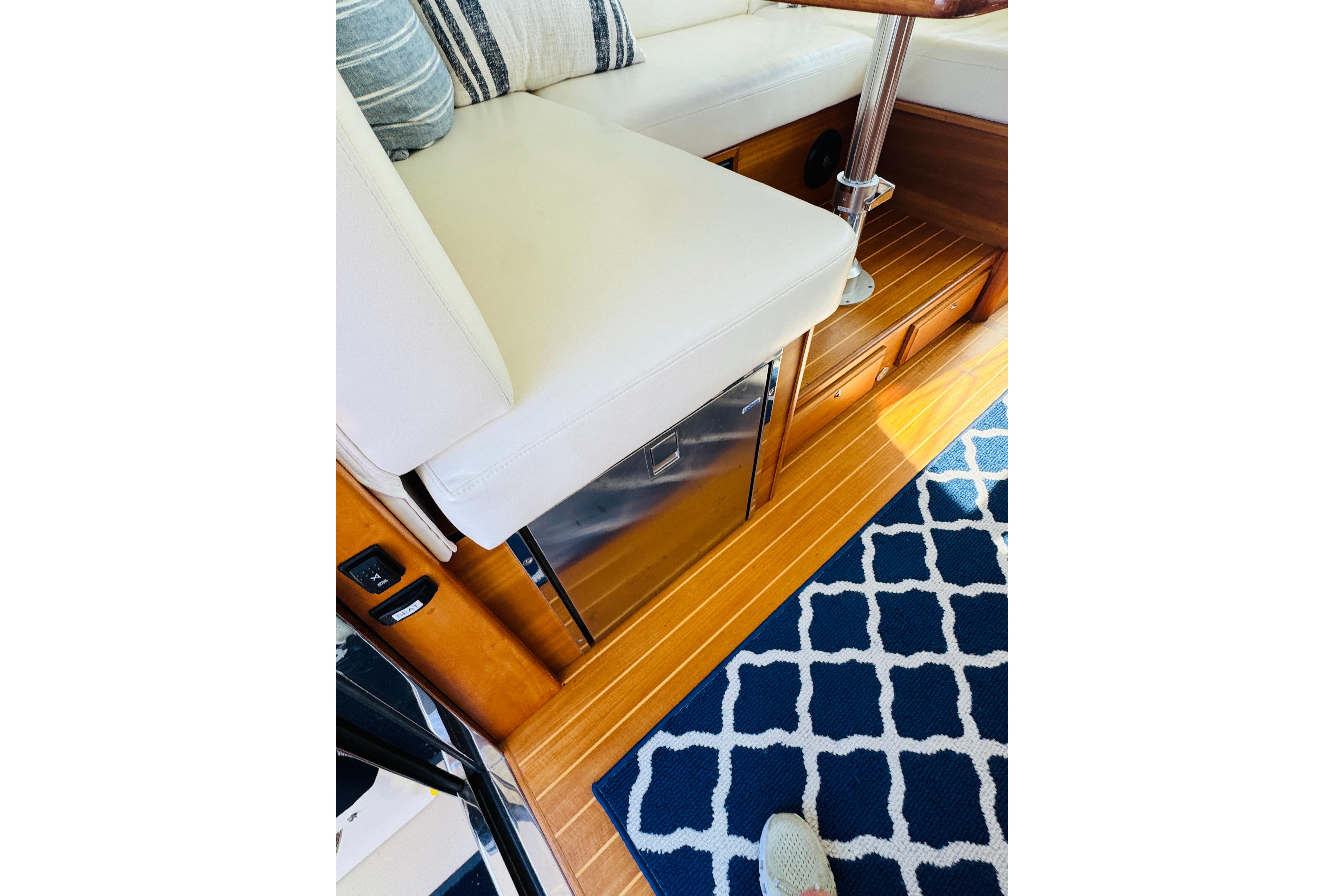 Interior of 2015 Sabre 38 Salon Express with white seating and wooden flooring.