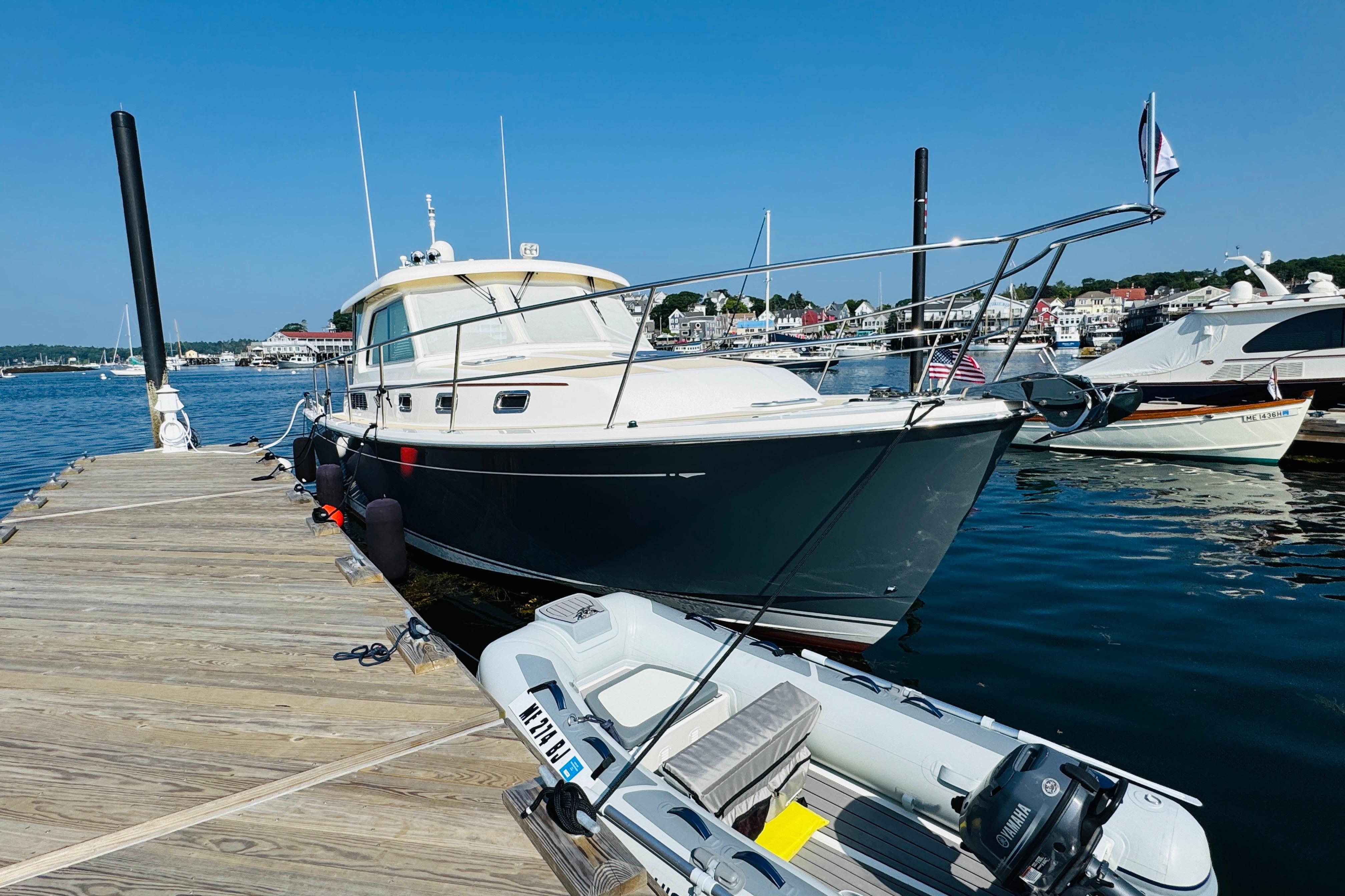 2015 Sabre 38 Salon Express yacht docked at marina on a sunny day.
