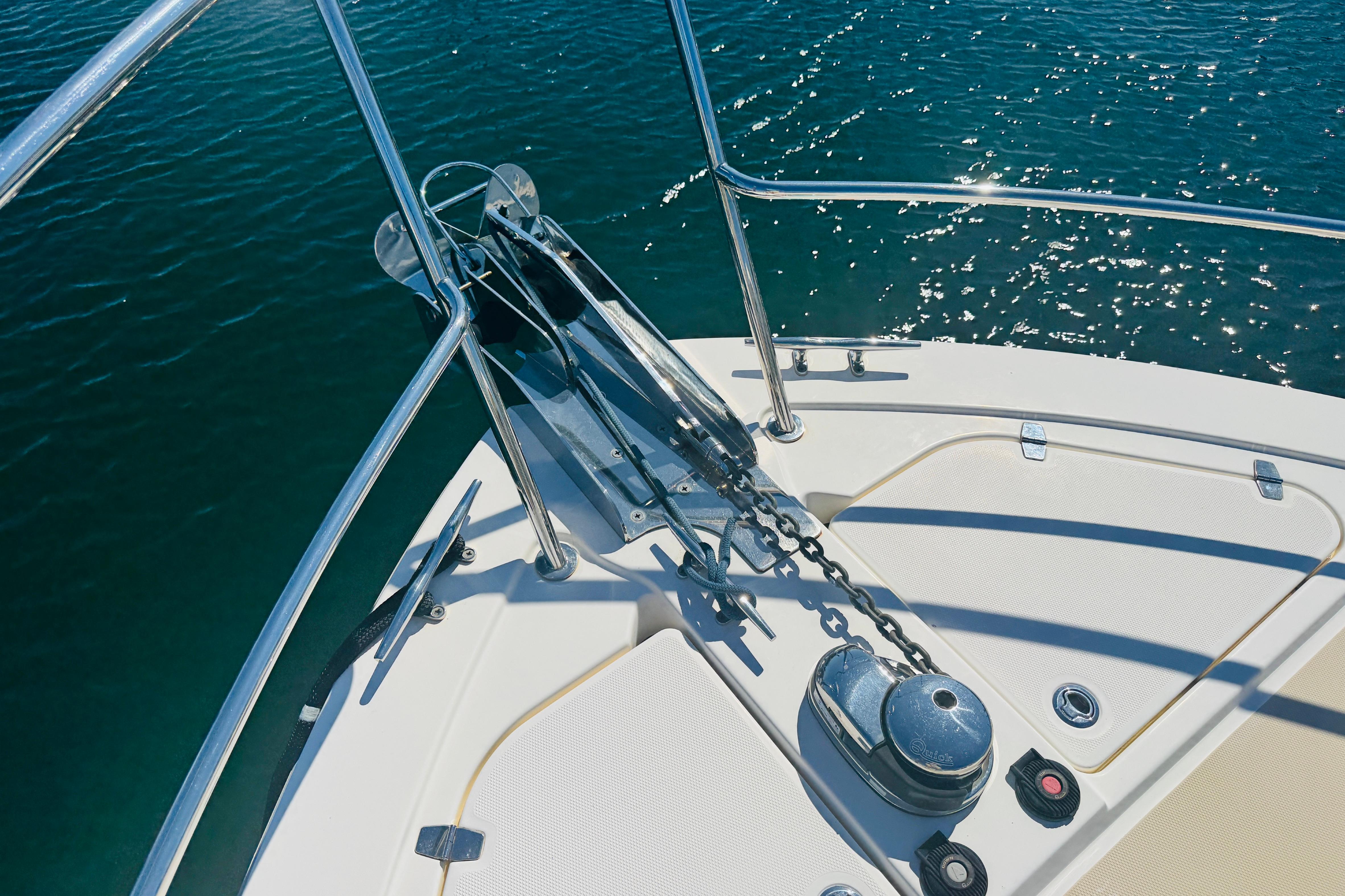 Bow of 2015 Sabre 38 Salon Express with anchor chain over sparkling water.