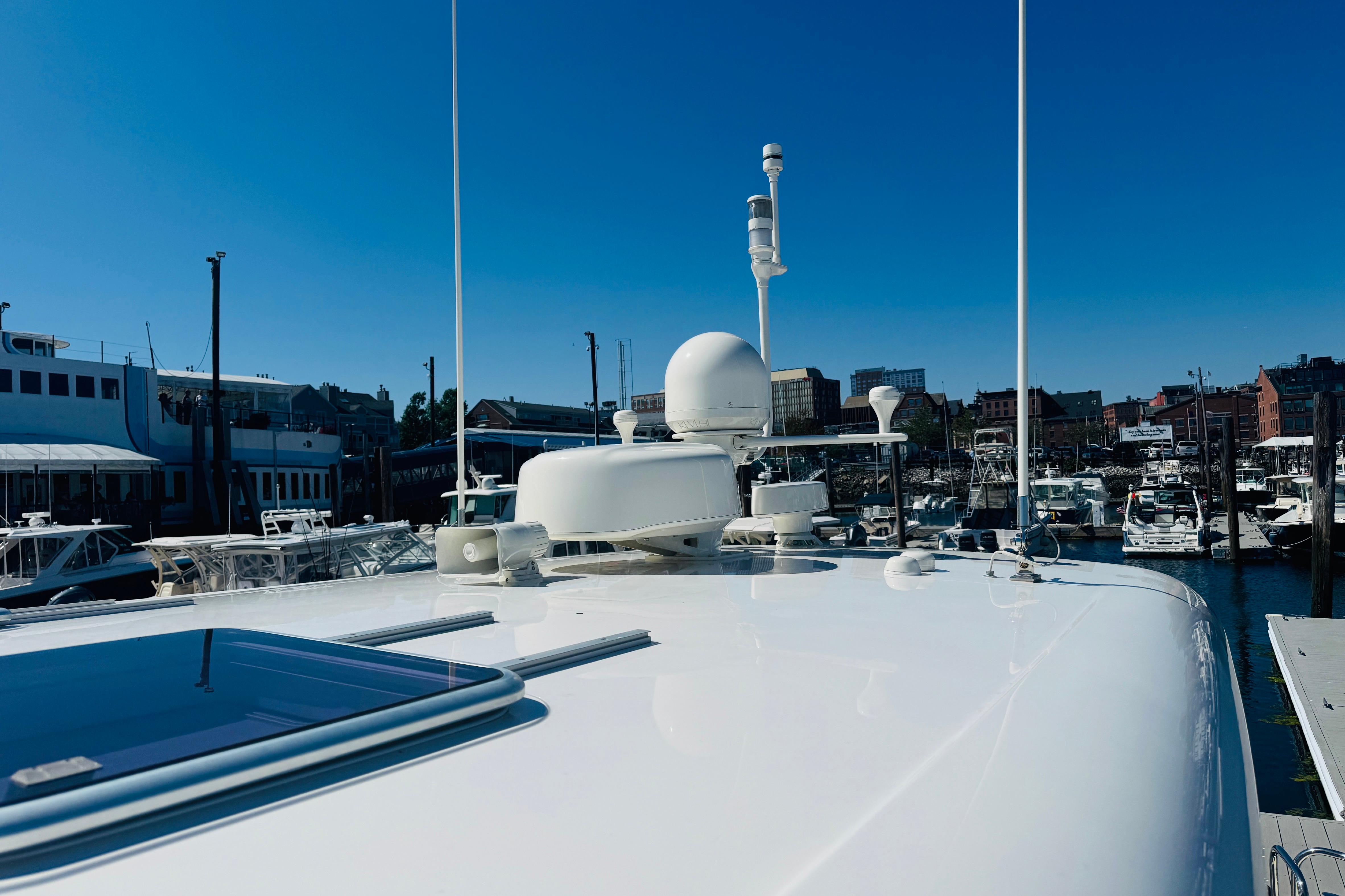 2015 Sabre 38 Salon Express yacht docked in a marina under clear blue skies.