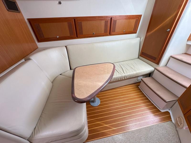 Cabo-Express 2004-TUNA DAZE MA-US-2004 Cabo Express yacht interior with beige seating, wooden cabinets, and stairs.-5384122 | Thumbnail