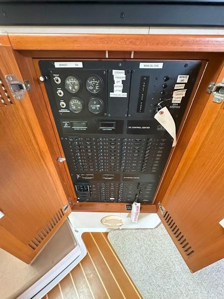 Cabo-Express 2004-TUNA DAZE MA-US-2004 Cabo Express electrical control panel with wooden cabinet doors open.-5384122 | Thumbnail