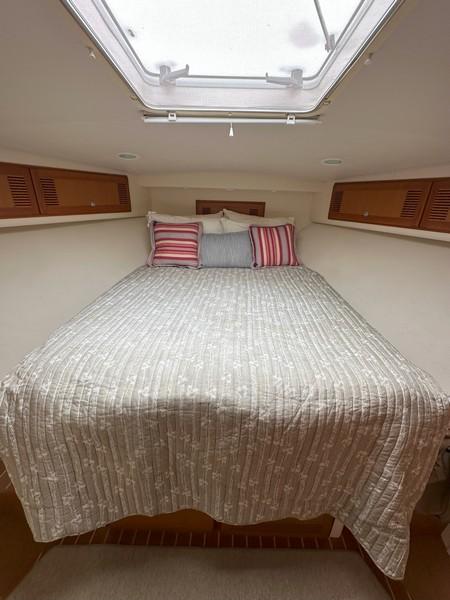 Cabo-Express 2004-TUNA DAZE MA-US-2004 Cabo Express boat cabin with cozy bed and striped pillows.-5384122 | Thumbnail