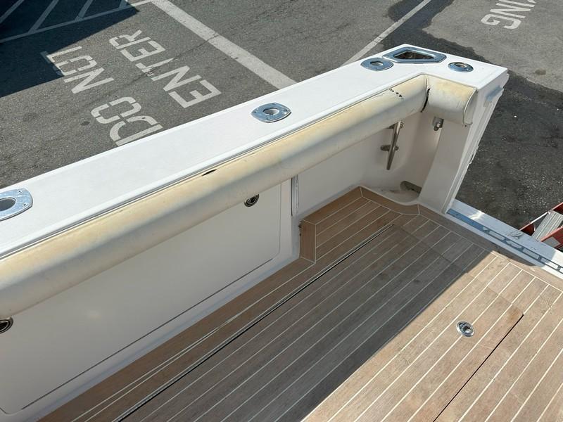 Cabo-Express 2004-TUNA DAZE MA-US-2004 Cabo Express boat deck with wood finish and storage compartments.-5384122 | Thumbnail