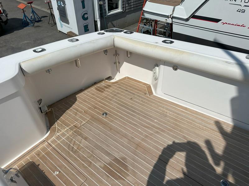 Cabo-Express 2004-TUNA DAZE MA-US-2004 Cabo Express boat deck with wooden flooring and white railing.-5384122 | Thumbnail