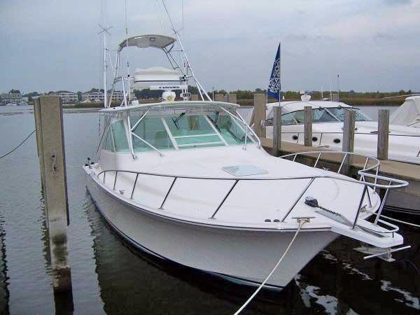 Cabo-Express 2004-TUNA DAZE MA-US-2004 Cabo Express boat docked at marina, overcast sky, calm water.-5384122 | Thumbnail