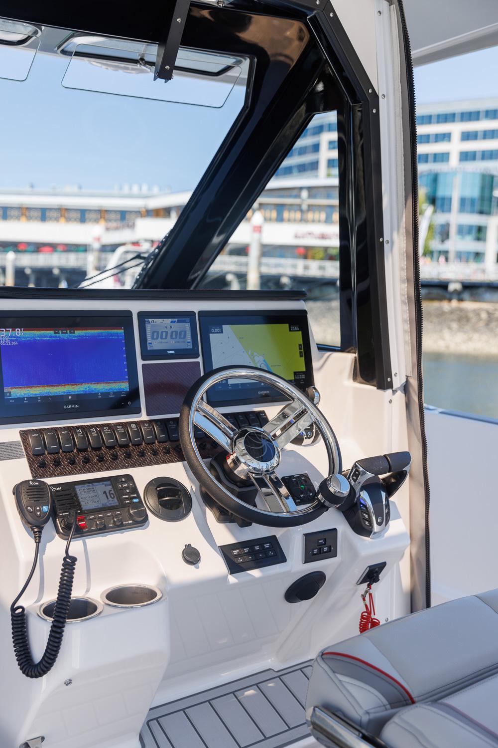 Solara-S-310 CW 2025 -FL-US-2025 Solara S-310 CW boat cockpit with advanced navigation systems and modern steering wheel.-9624144 | Thumbnail