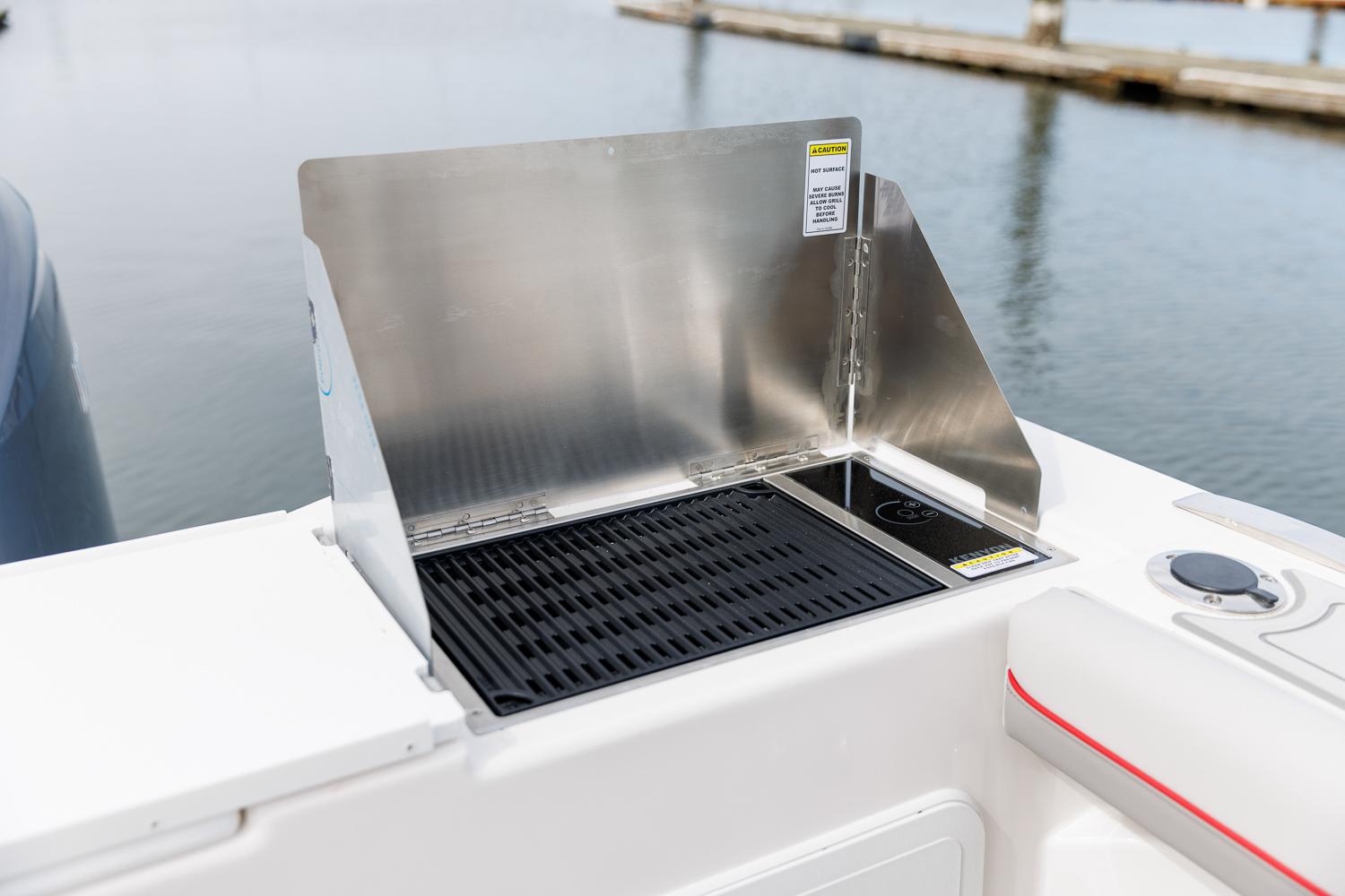 Solara-S-310 CW 2025 -FL-US-Outdoor grill on Solara S-310 CW boat, 2025 model, by the water.-9624144 | Thumbnail