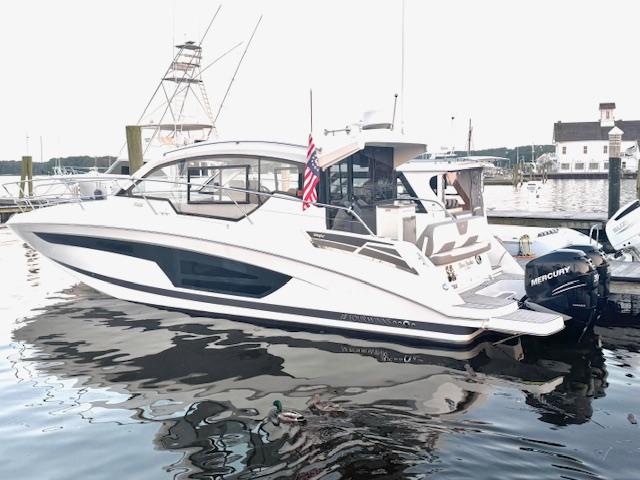 2020 Four Winns Vista 355 Coupe OB docked with Mercury outboard engines.