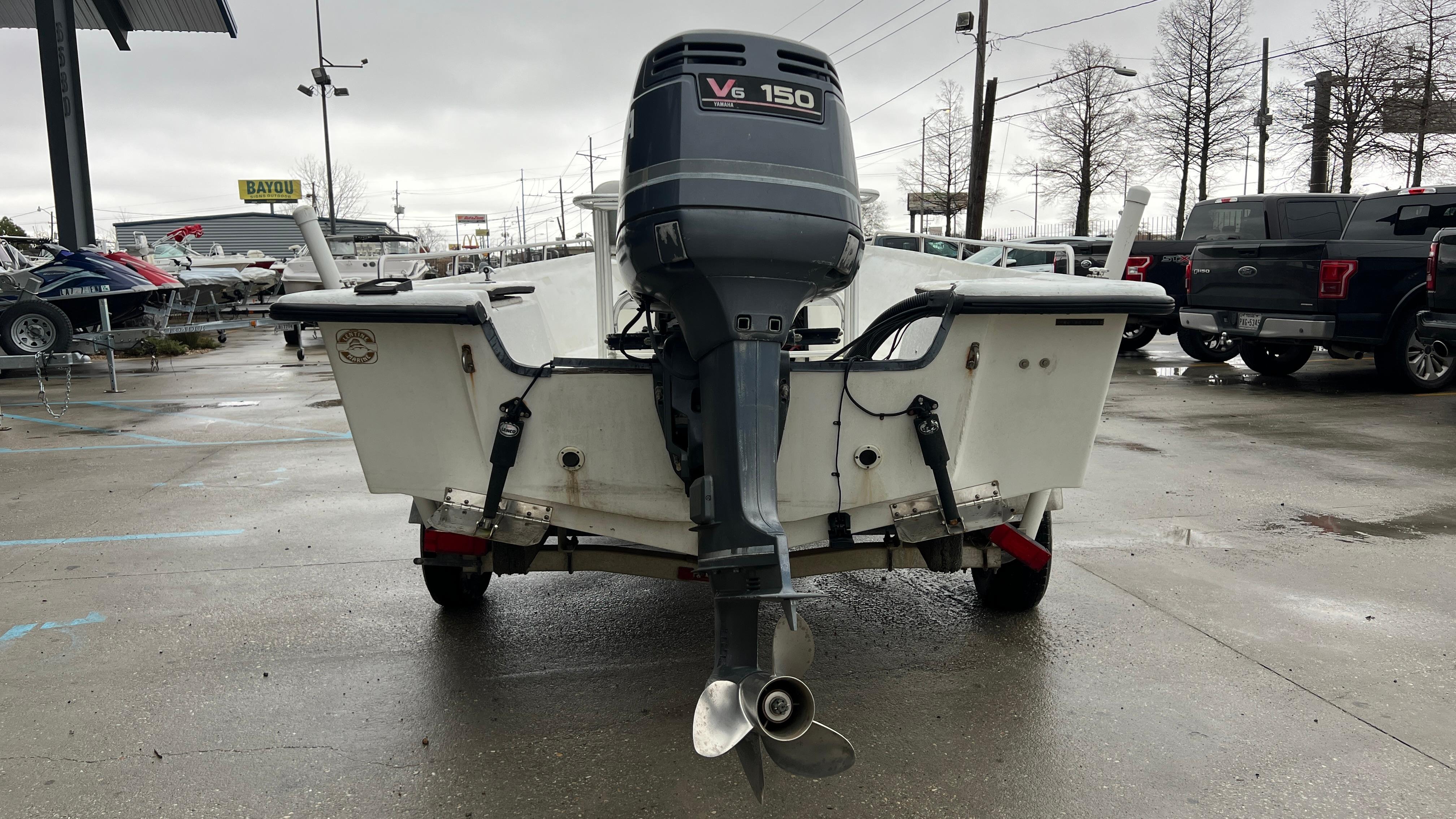 Rear view of a 2000 Blazer 1860 boat with V6 150 outboard motor.