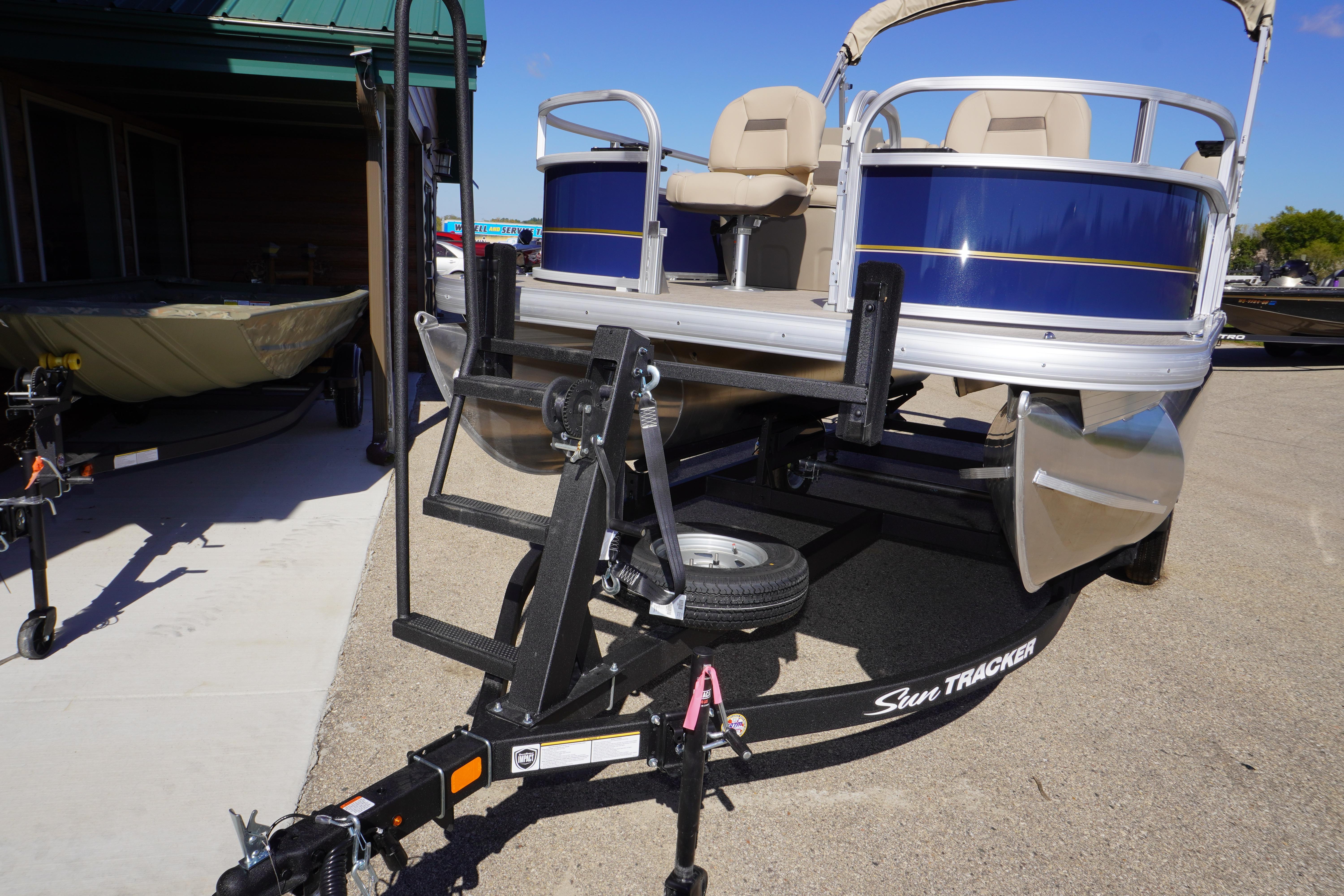 2025 Sun Tracker Bass Buggy 16 XL Select pontoon boat on trailer, outdoor display.