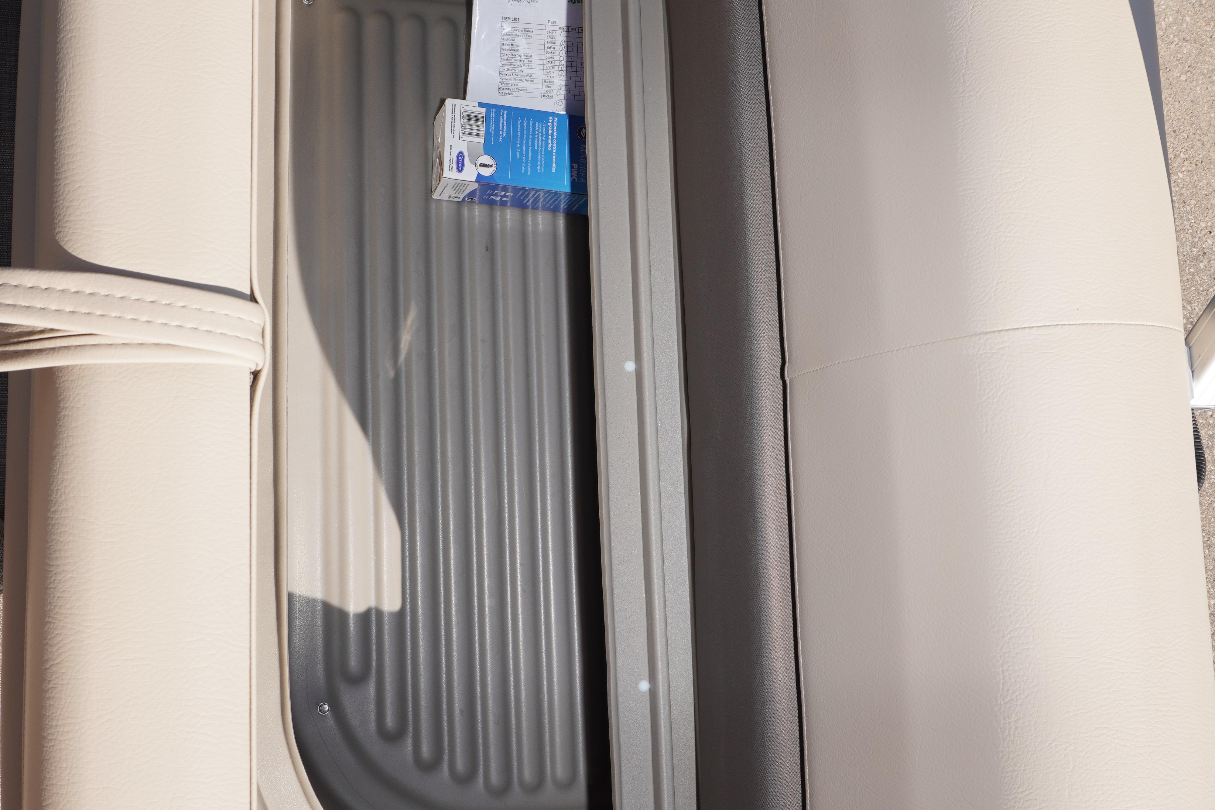 2025 Sun Tracker Bass Buggy 16 XL Select interior storage compartment with beige seating.