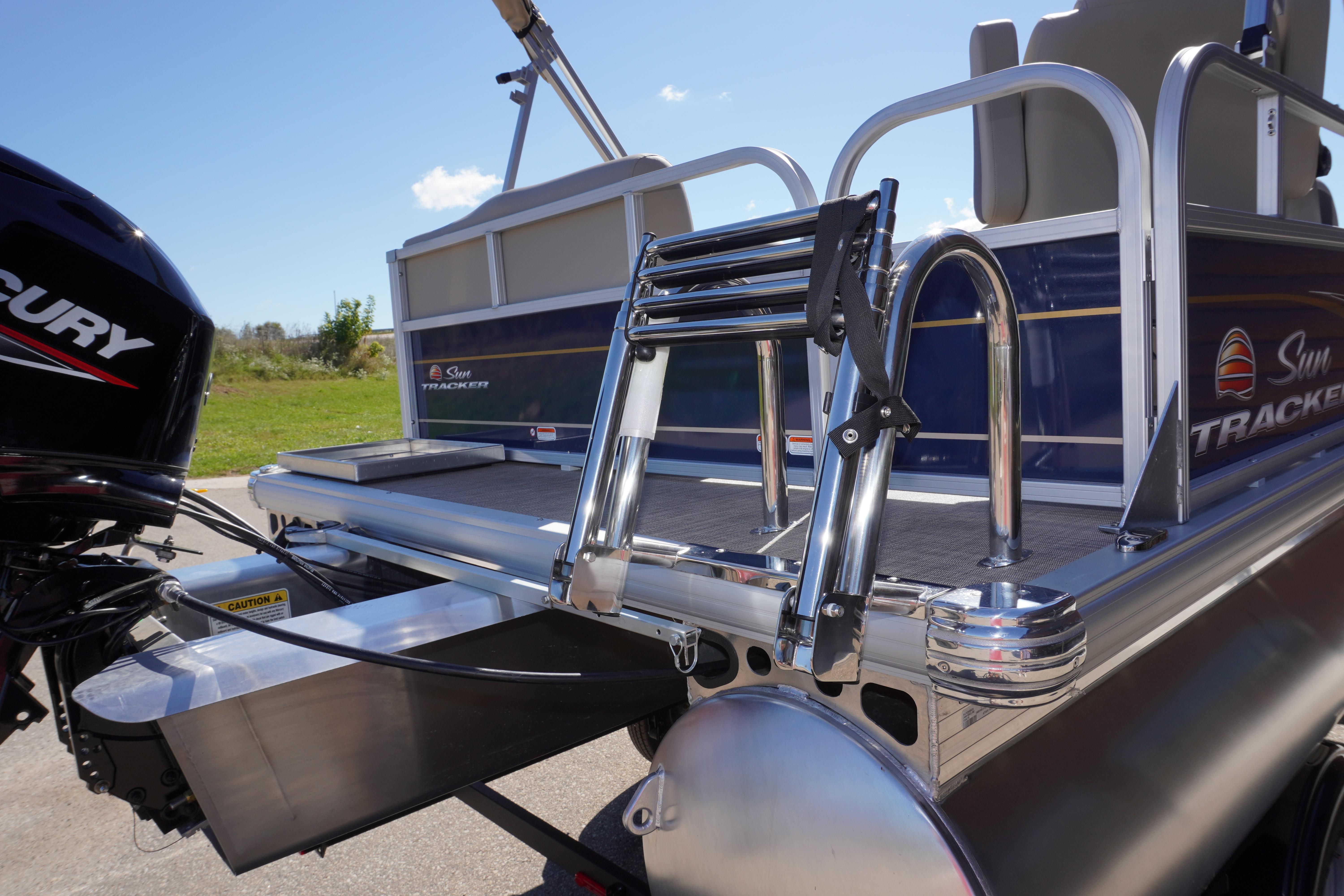 2025 Sun Tracker Bass Buggy 16 XL Select pontoon boat with Mercury engine and swim ladder.