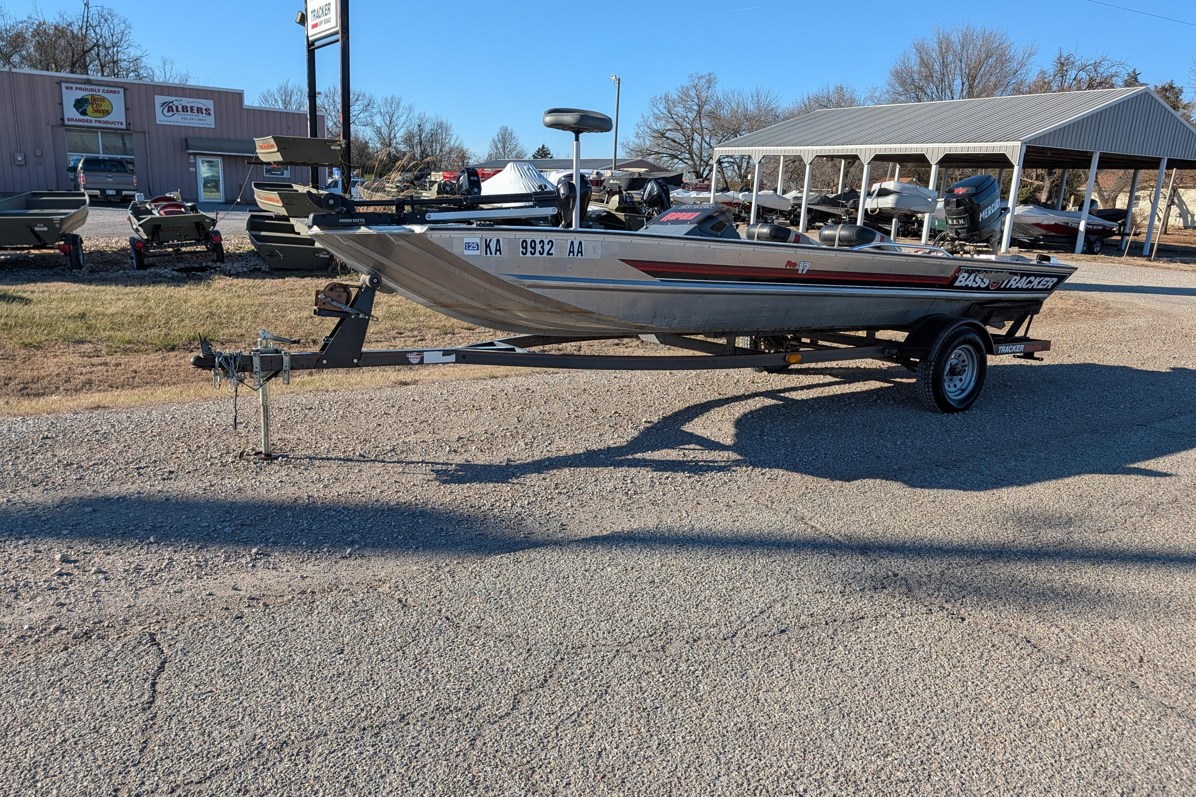 1988 Bass Tracker Pro 17 boat on trailer in outdoor dealership lot.