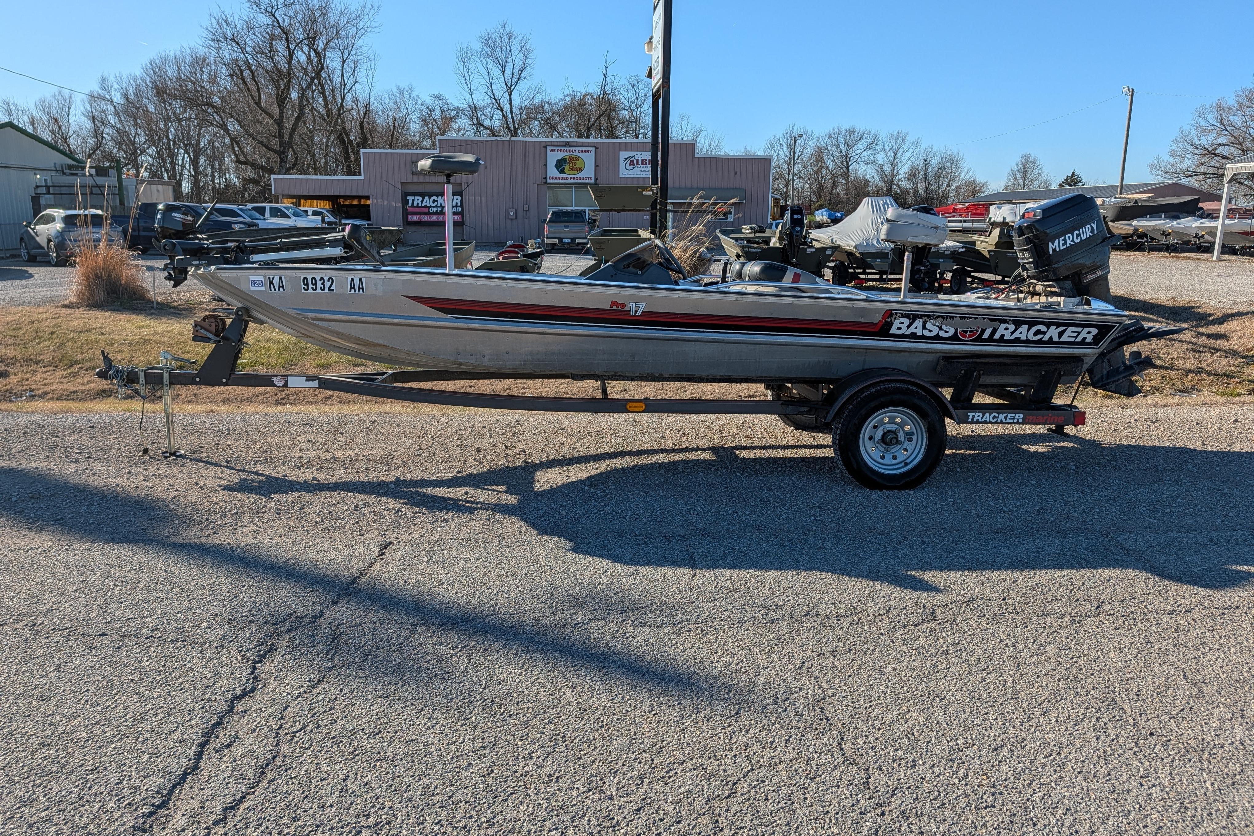 1988 Bass Tracker Pro 17 boat on trailer, parked outdoors in a dealership lot.