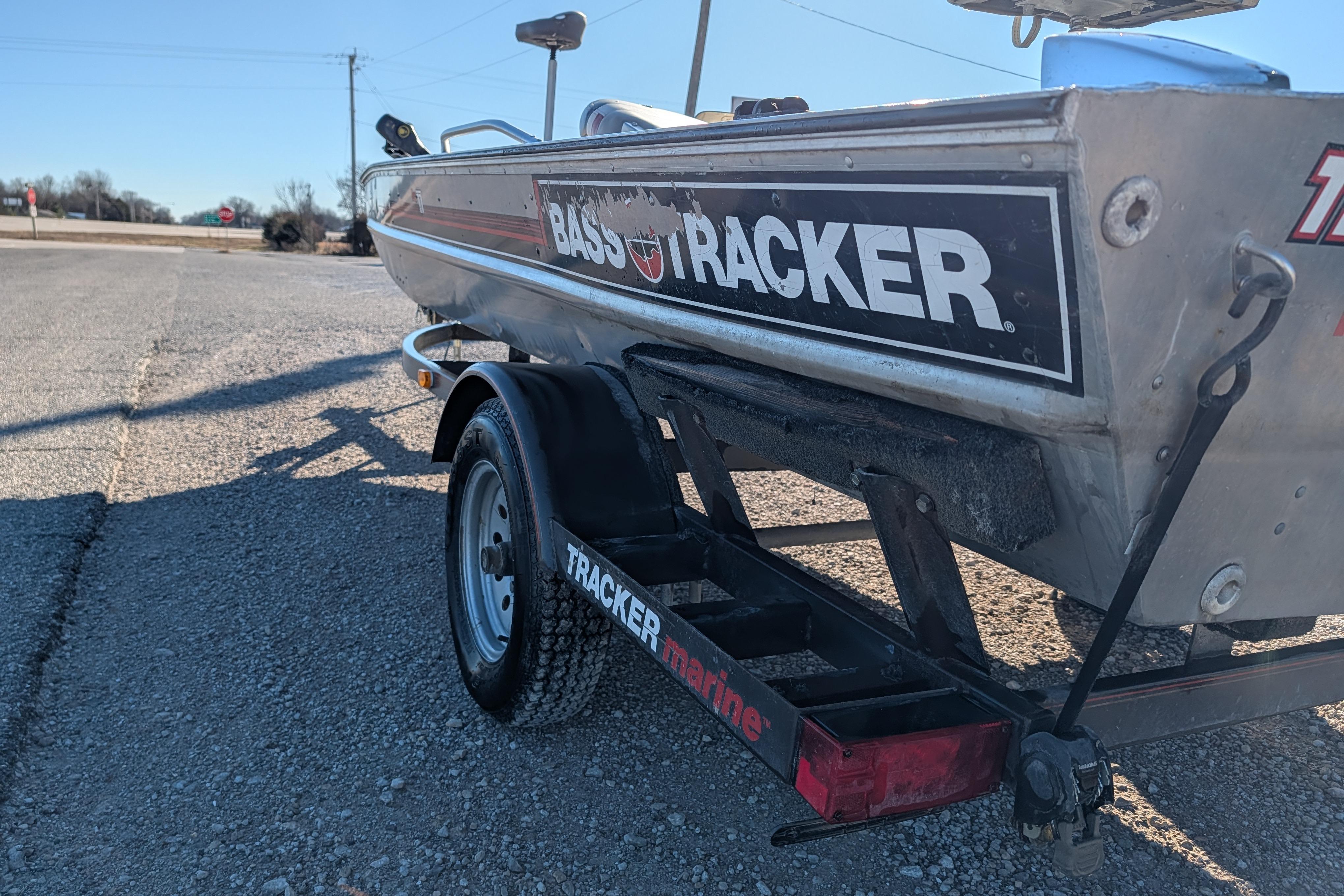 1988 Bass Tracker Pro 17 boat on trailer, parked on gravel road.