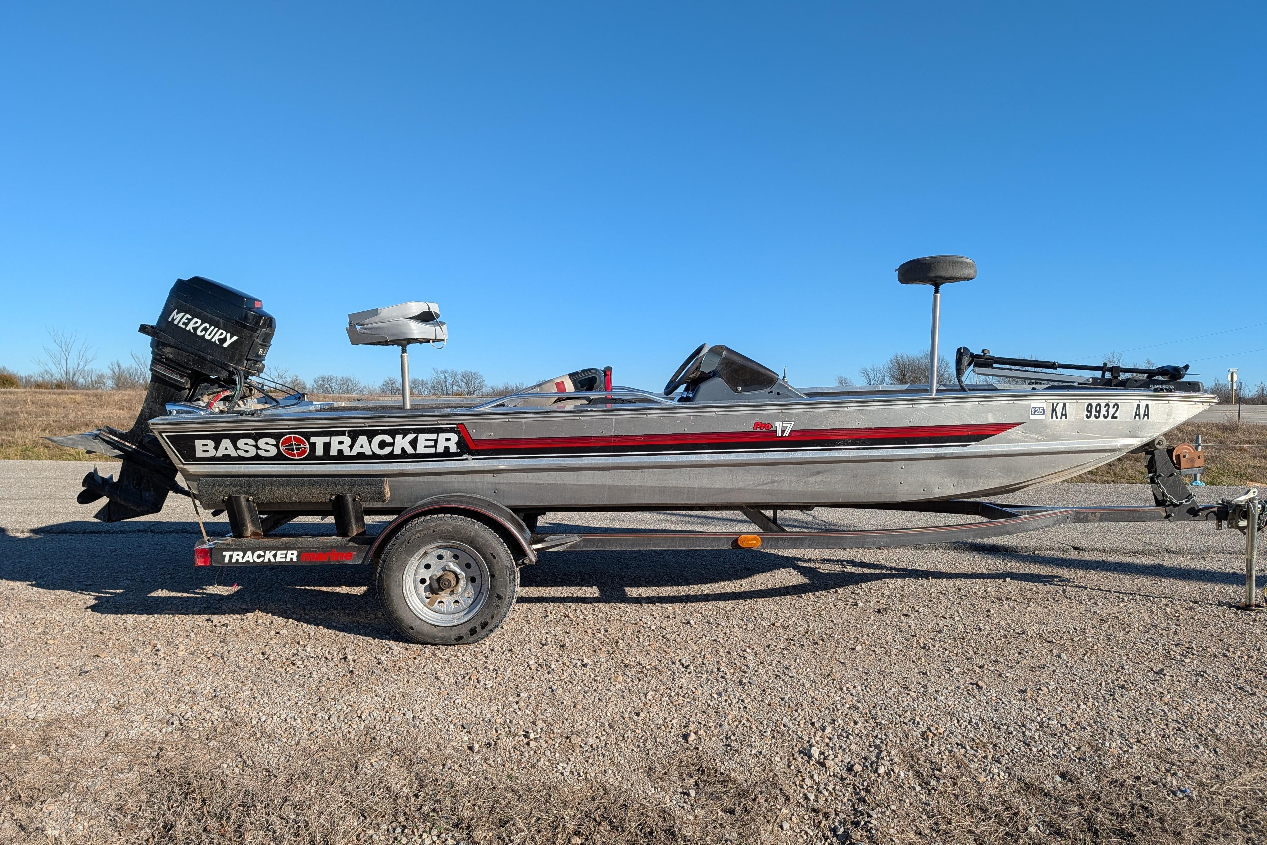 1988 Bass Tracker Pro 17 boat with Mercury engine on trailer, parked outdoors.