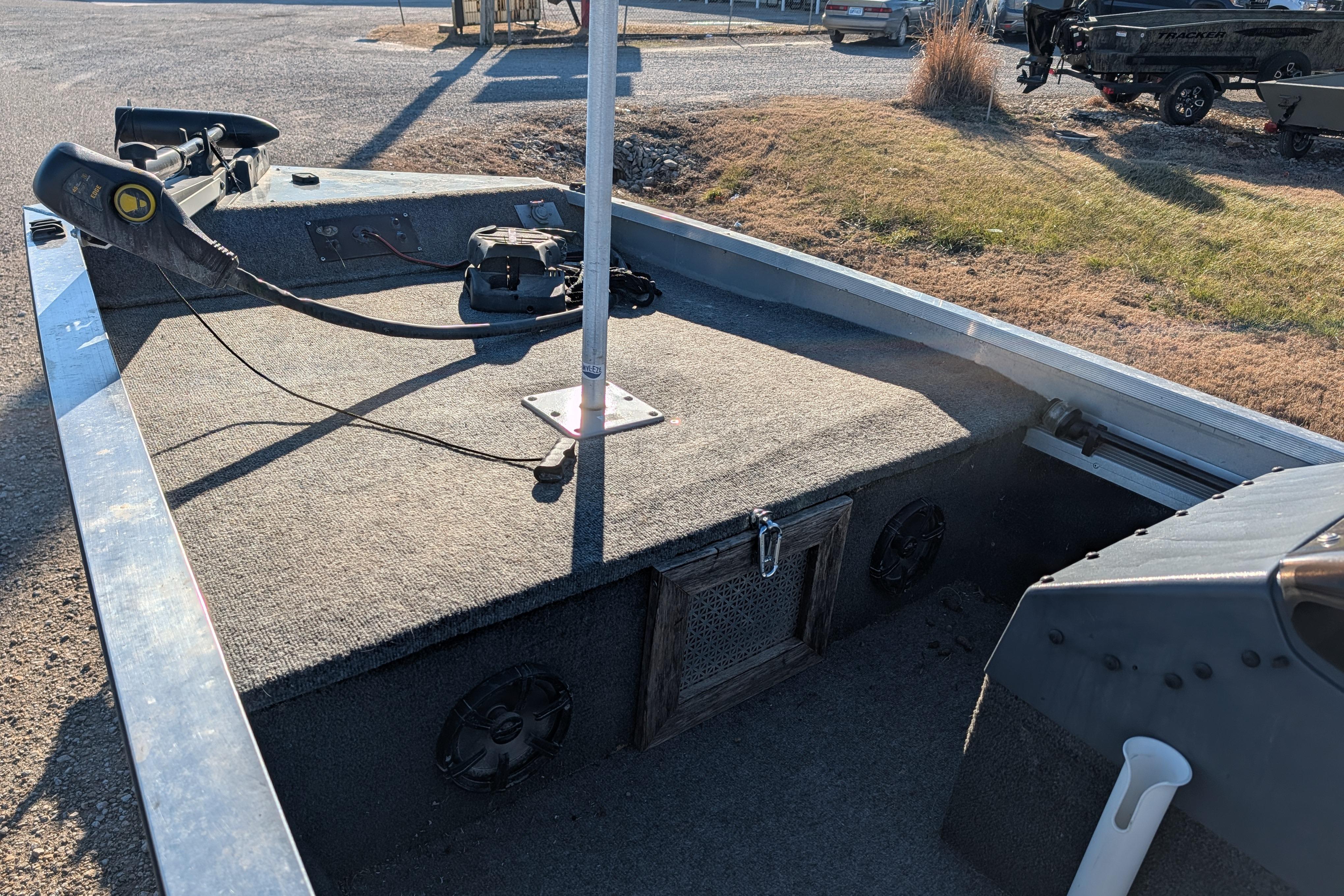 1988 Bass Tracker Pro 17 boat interior with trolling motor and carpeted deck.