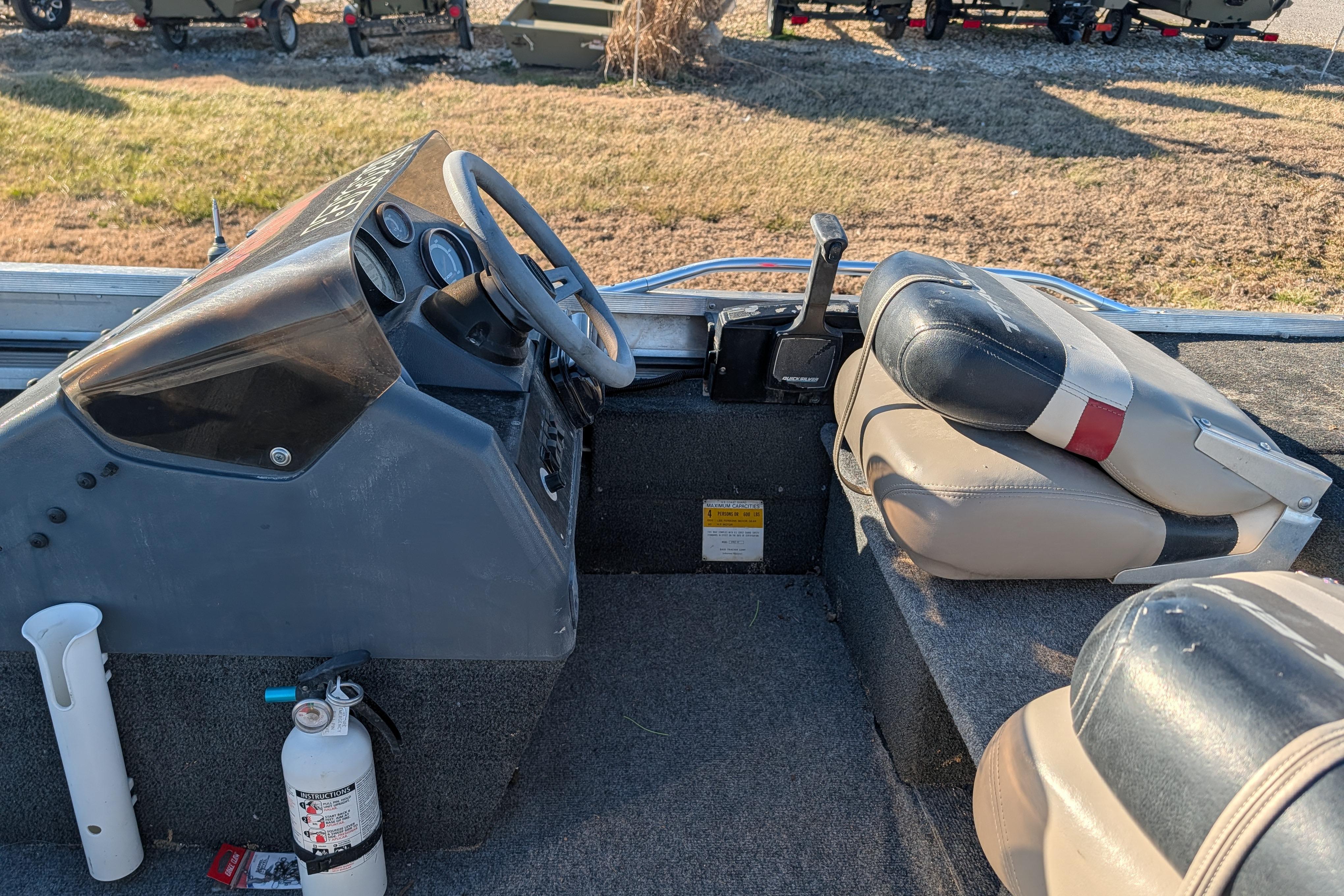 1988 Bass Tracker Pro 17 boat interior with steering wheel and seats.