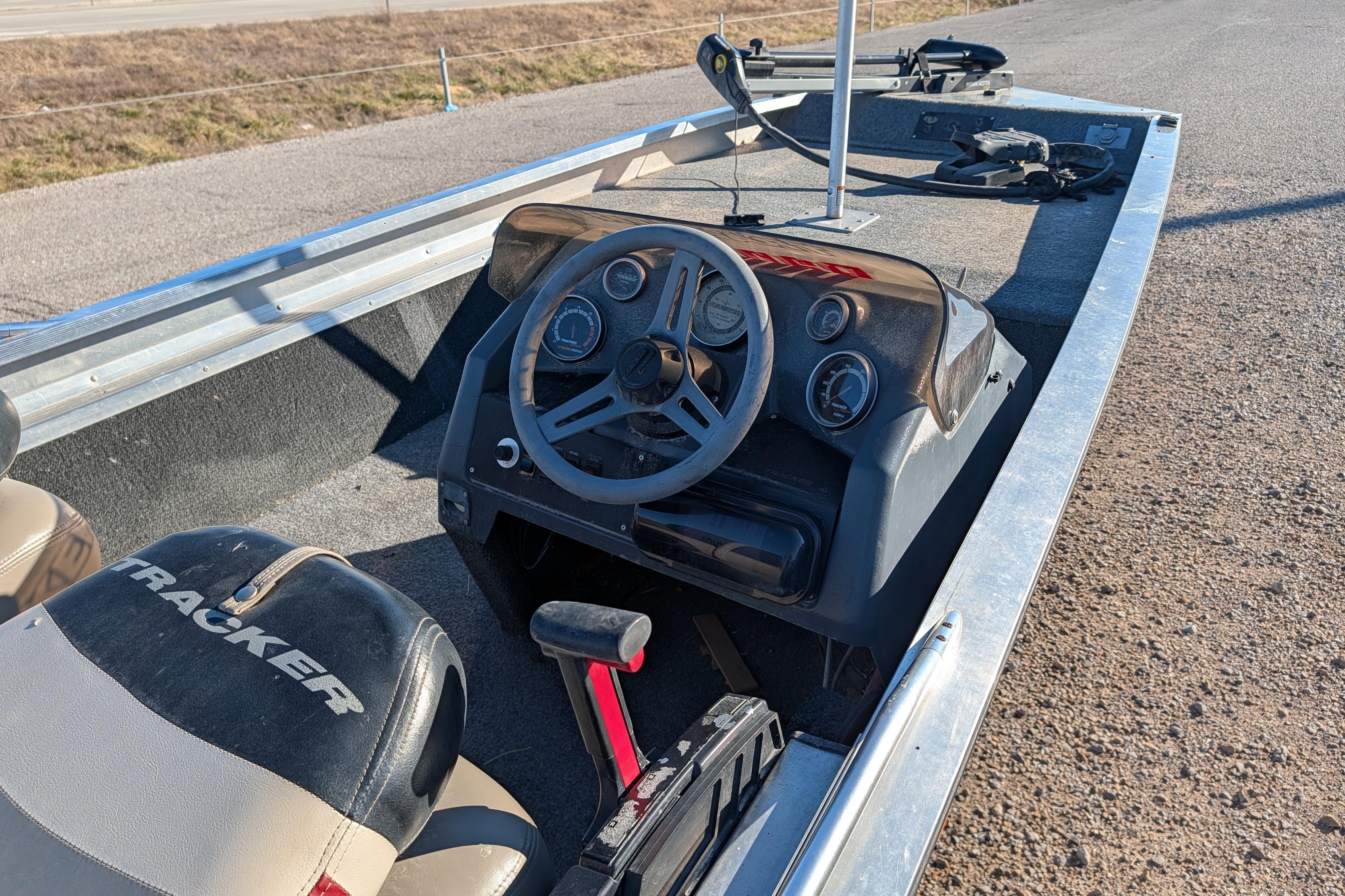 1988 Bass Tracker Pro 17 boat interior with steering wheel and dashboard controls.