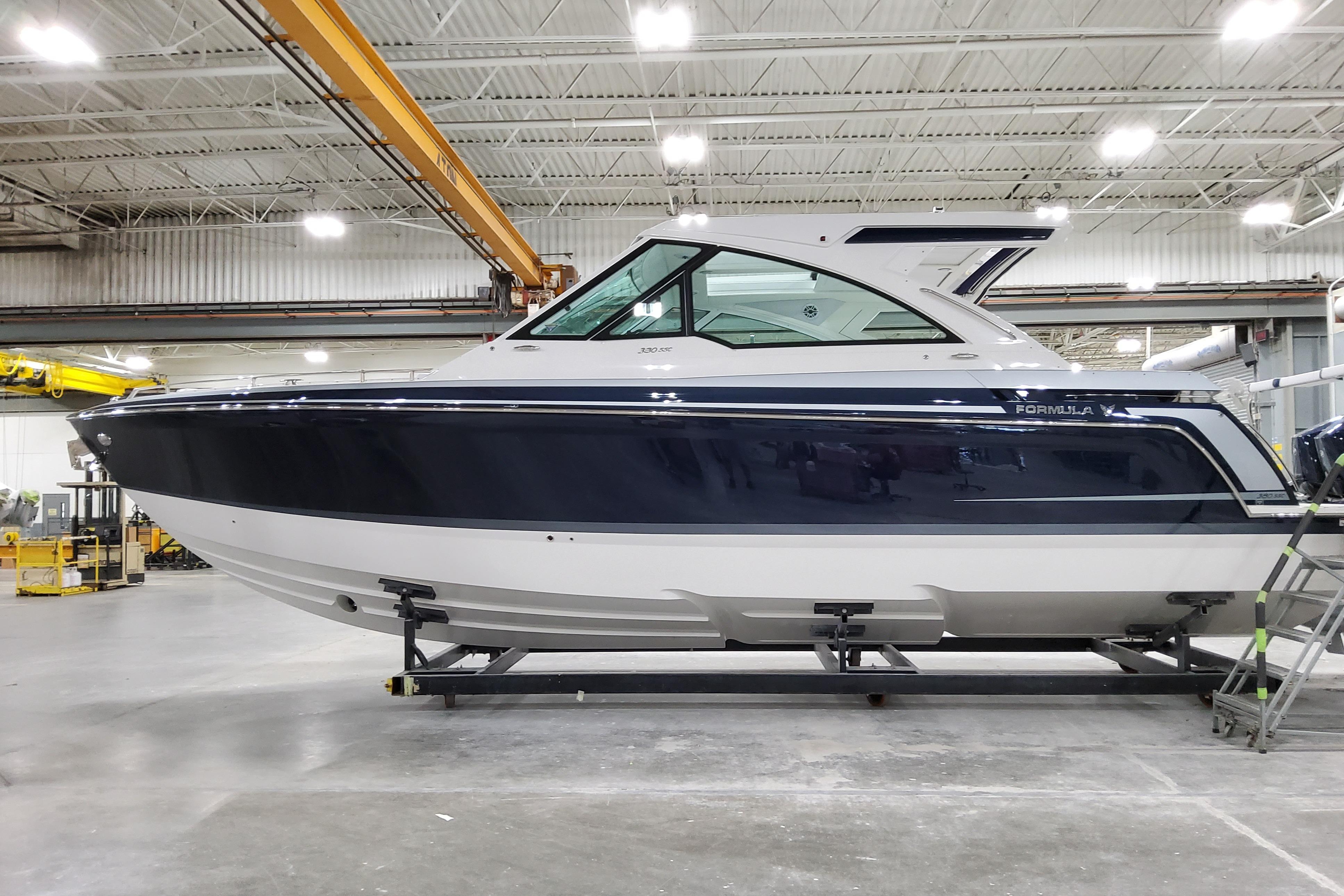 2026 Formula 380 Super Sport Crossover OB boat in a warehouse setting.