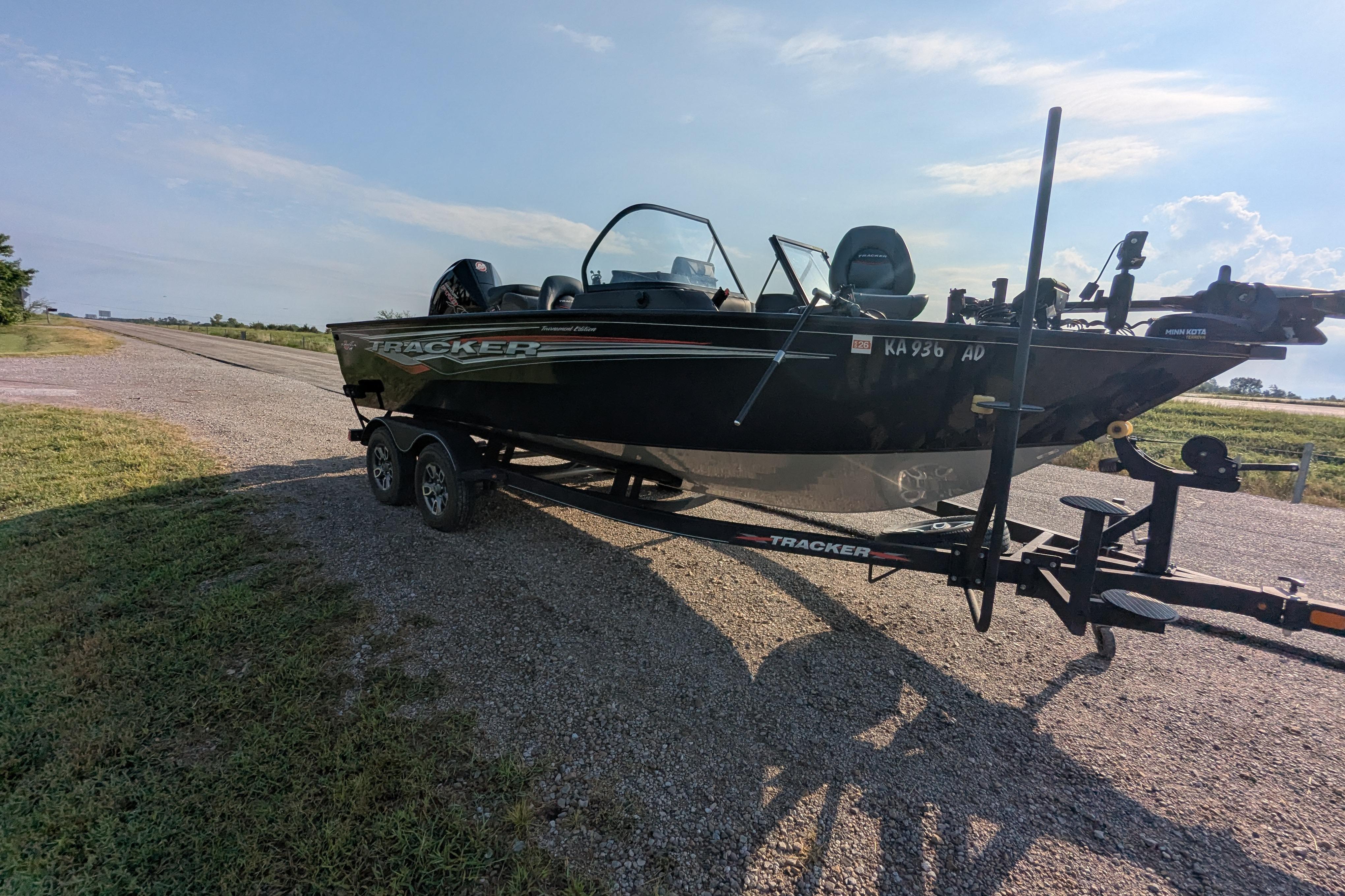 2023 Tracker Targa V-19 Combo Tournament Edition boat on trailer, parked on gravel road.
