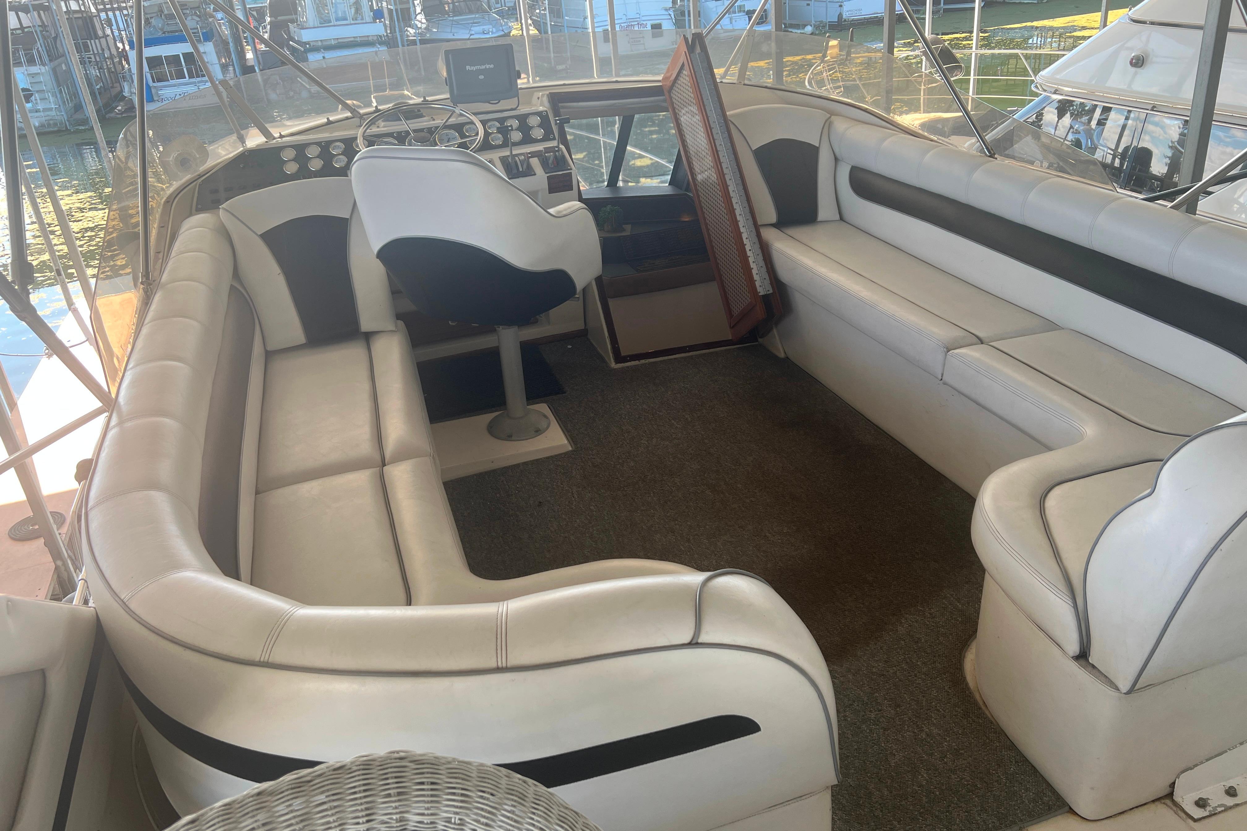 1986 Bayliner 4550 Motoryacht flybridge with white seating and helm station.