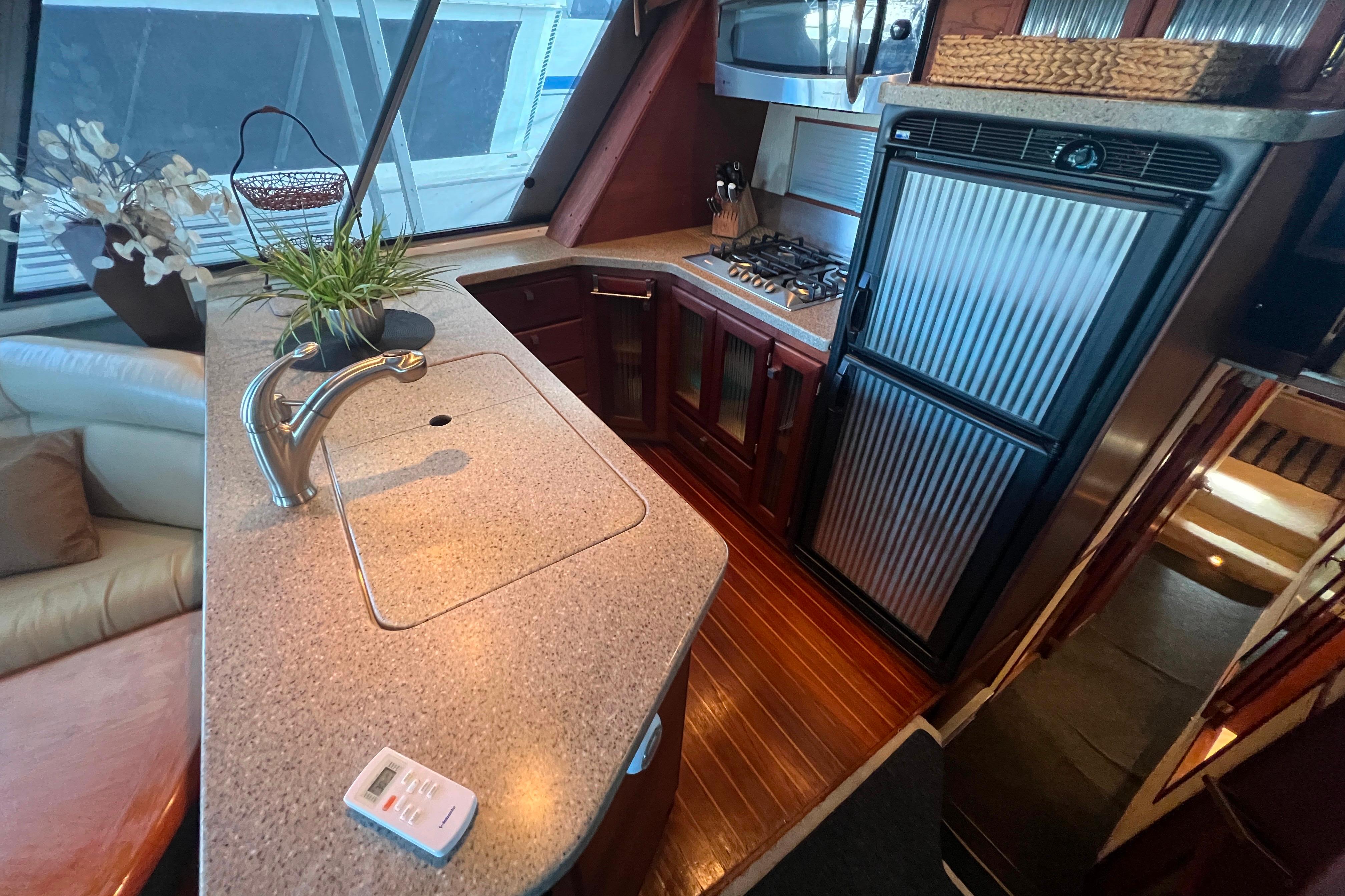 Galley with modern appliances and original teak and holly wood flooring.