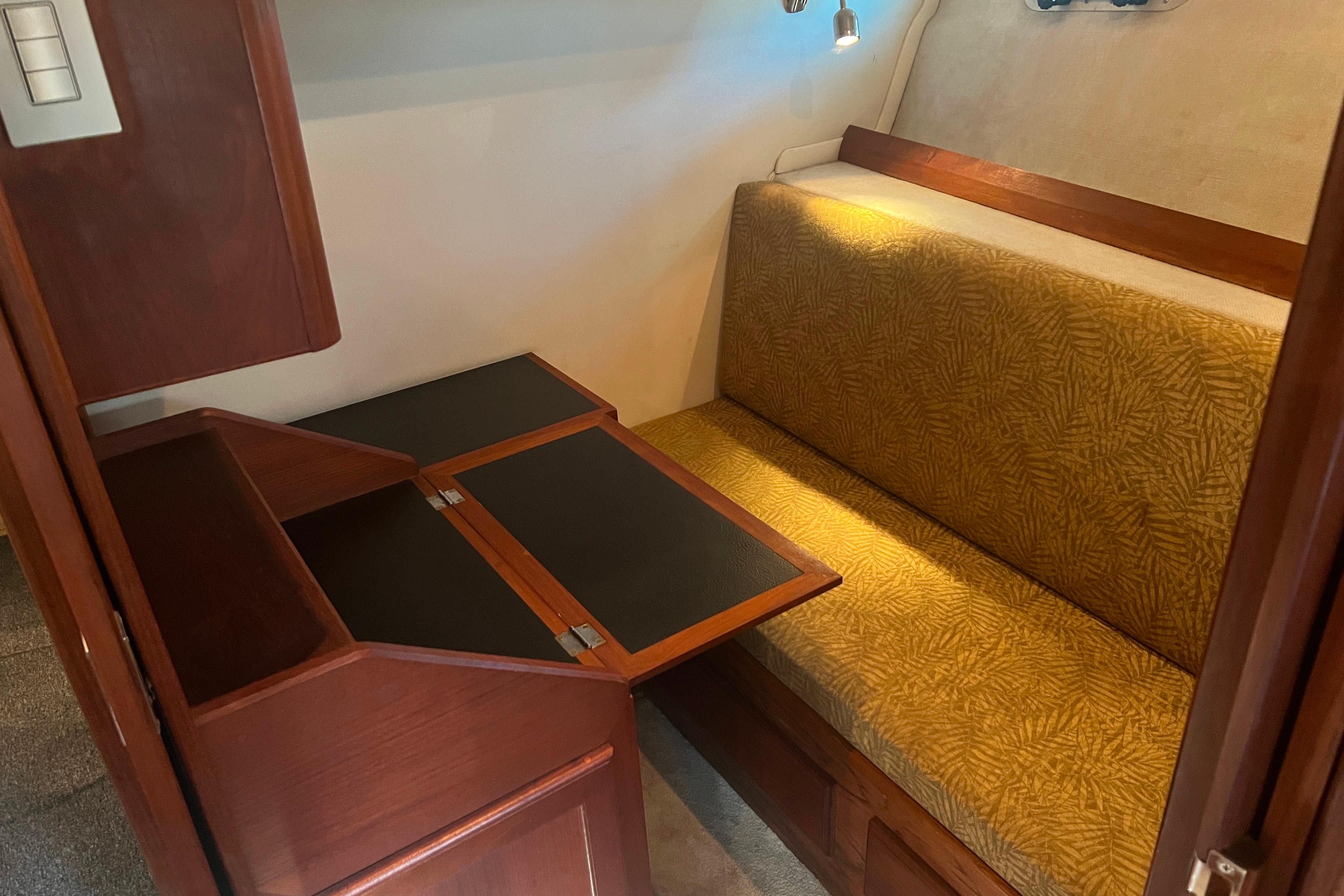1986 Bayliner 4550 Motoryacht interior with foldable table and cushioned seating.