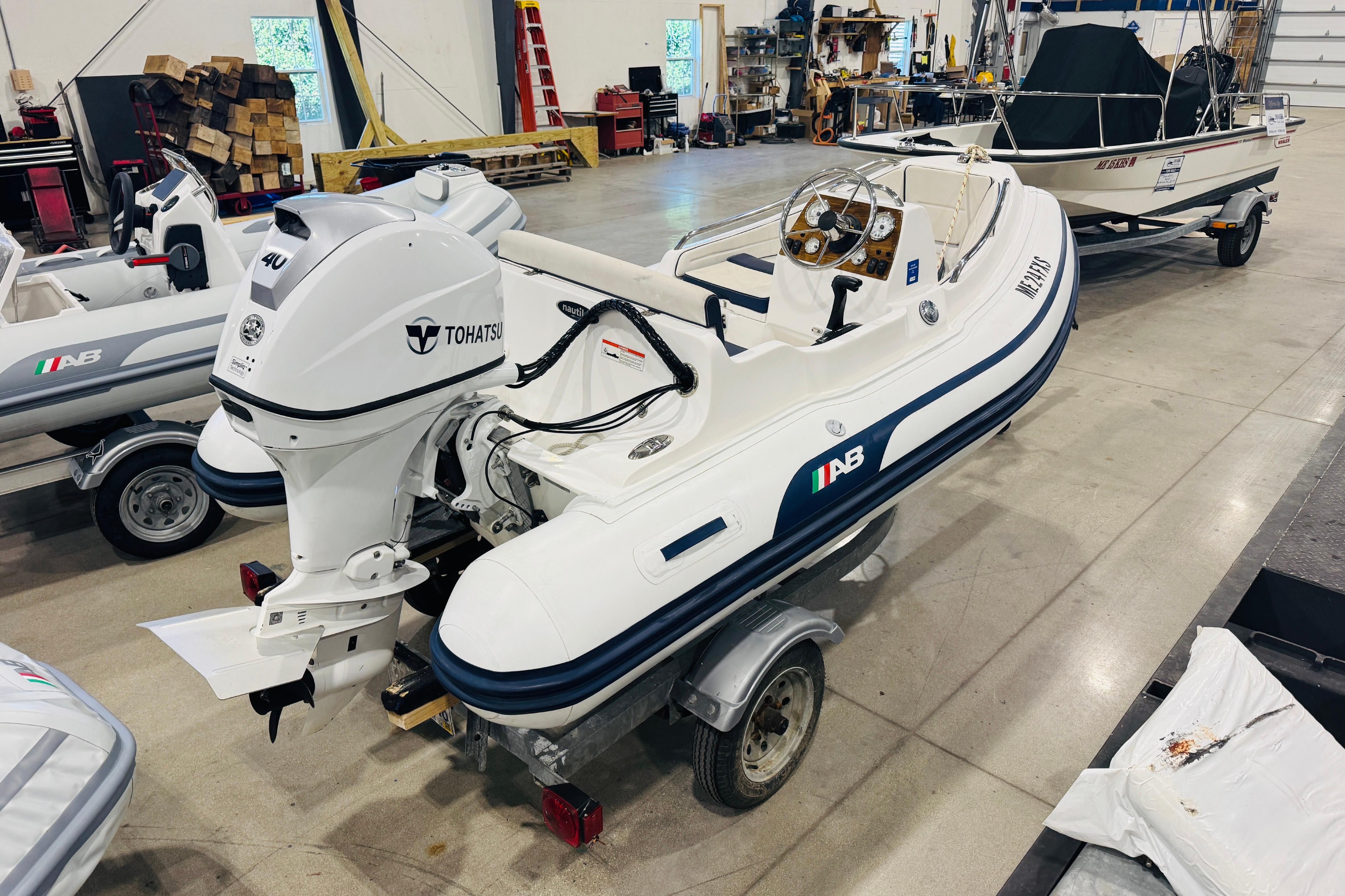 2019 AB Inflatables Nautilus 11 DLX with Tohatsu engine in a workshop setting.