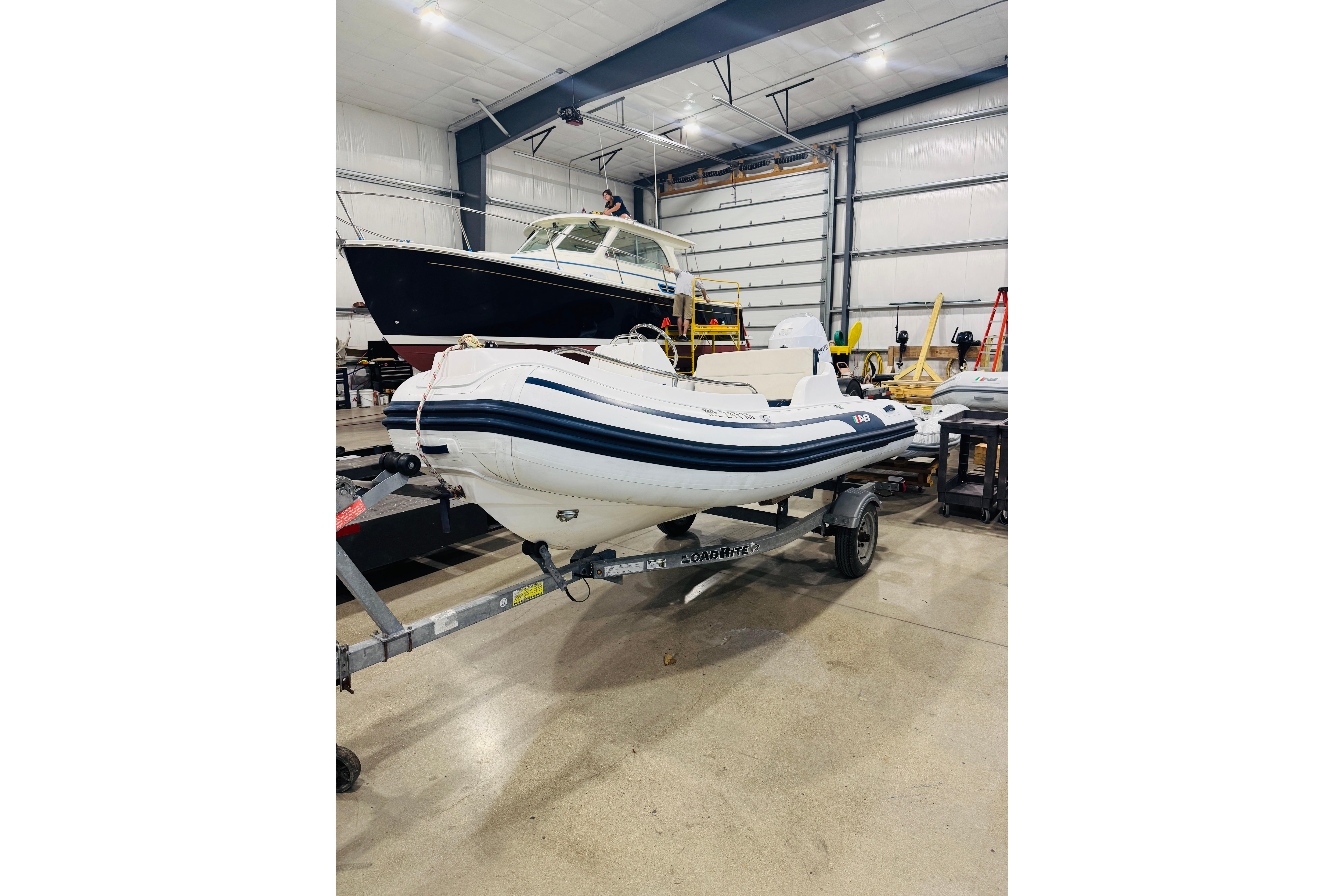 2019 AB Inflatables Nautilus 11 DLX boat on trailer in indoor storage facility.
