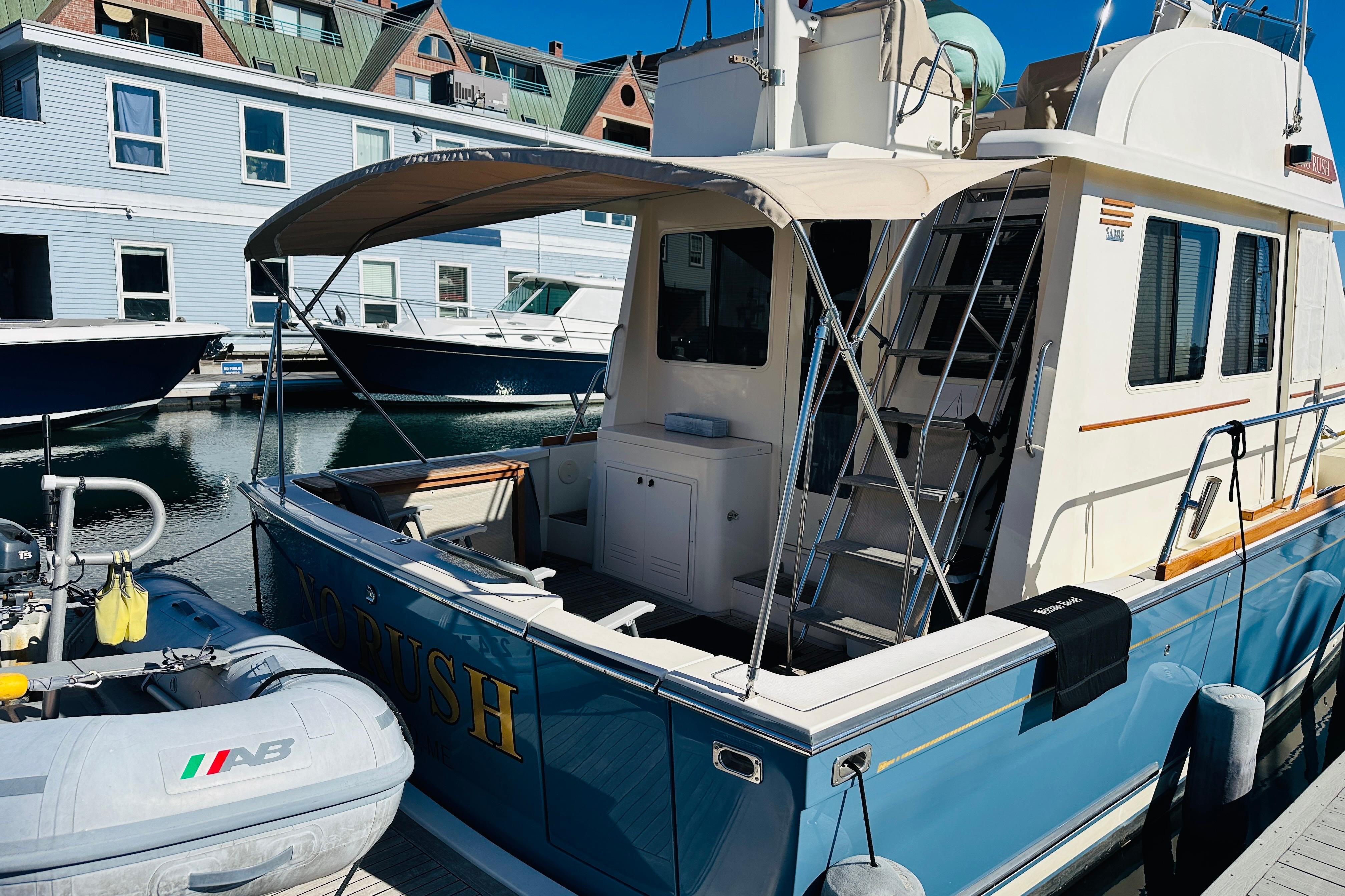 2006 Sabre 42 Fly Bridge yacht docked, featuring a spacious deck and elegant design.