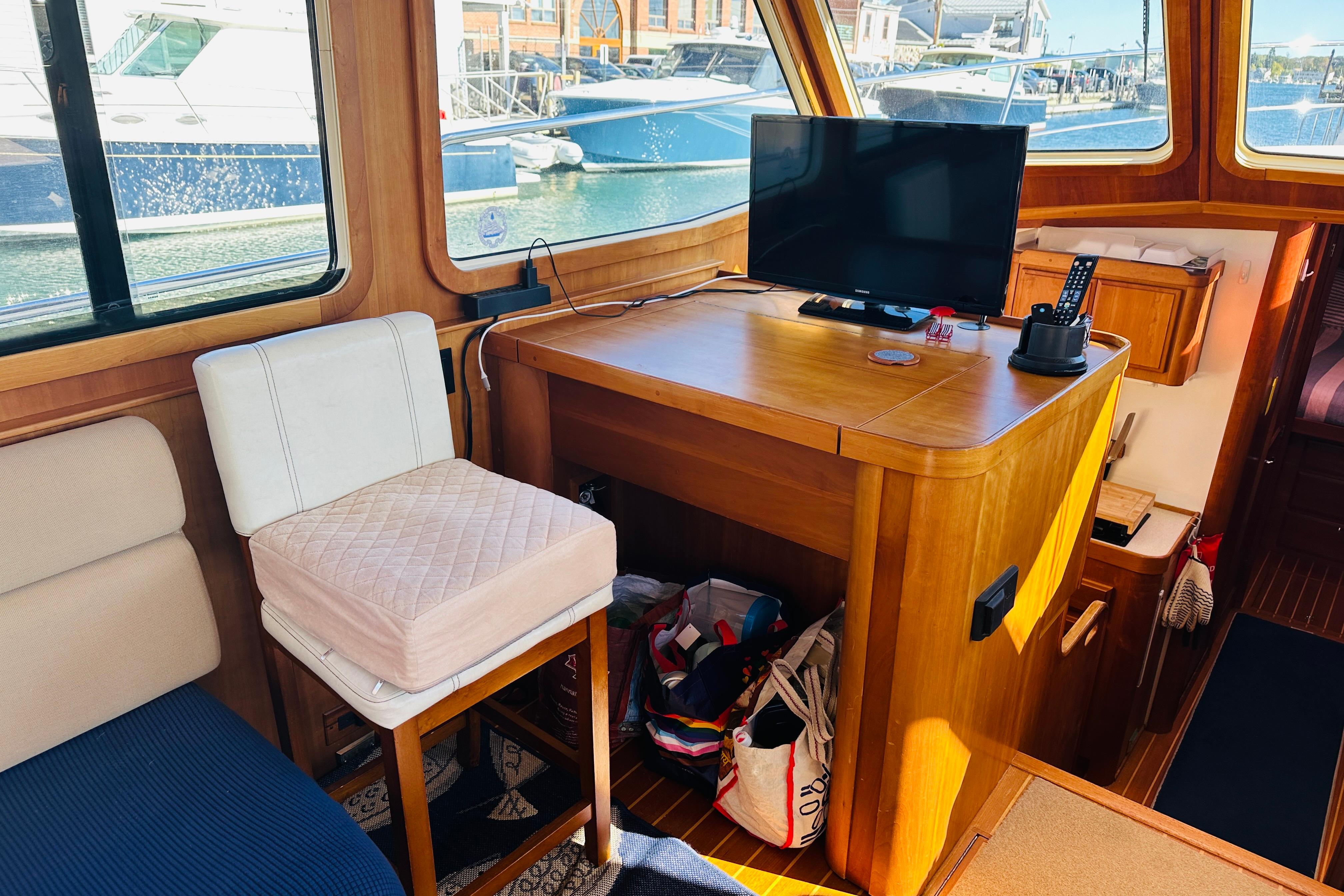 Interior of 2006 Sabre 42 Fly Bridge with TV, chair, and wooden cabinetry.