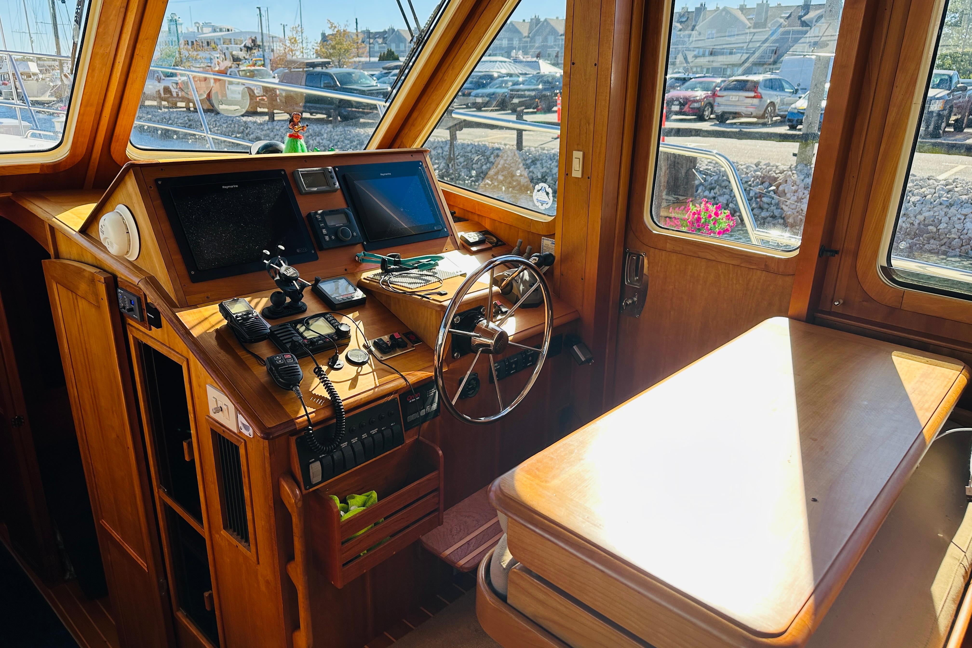 2006 Sabre 42 Fly Bridge helm with wooden interior and navigation equipment.