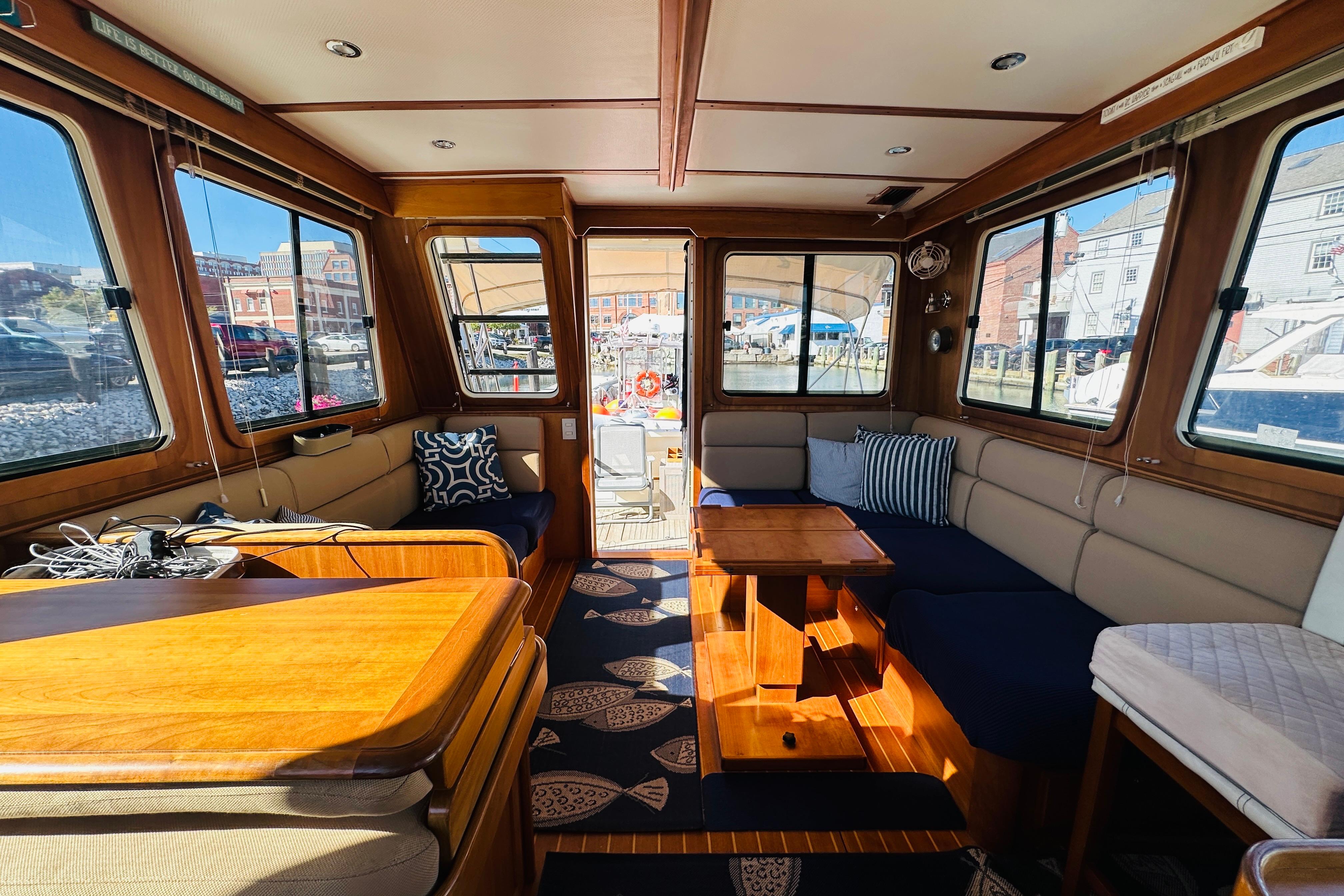 Interior of 2006 Sabre 42 Fly Bridge yacht with wooden furnishings and large windows.