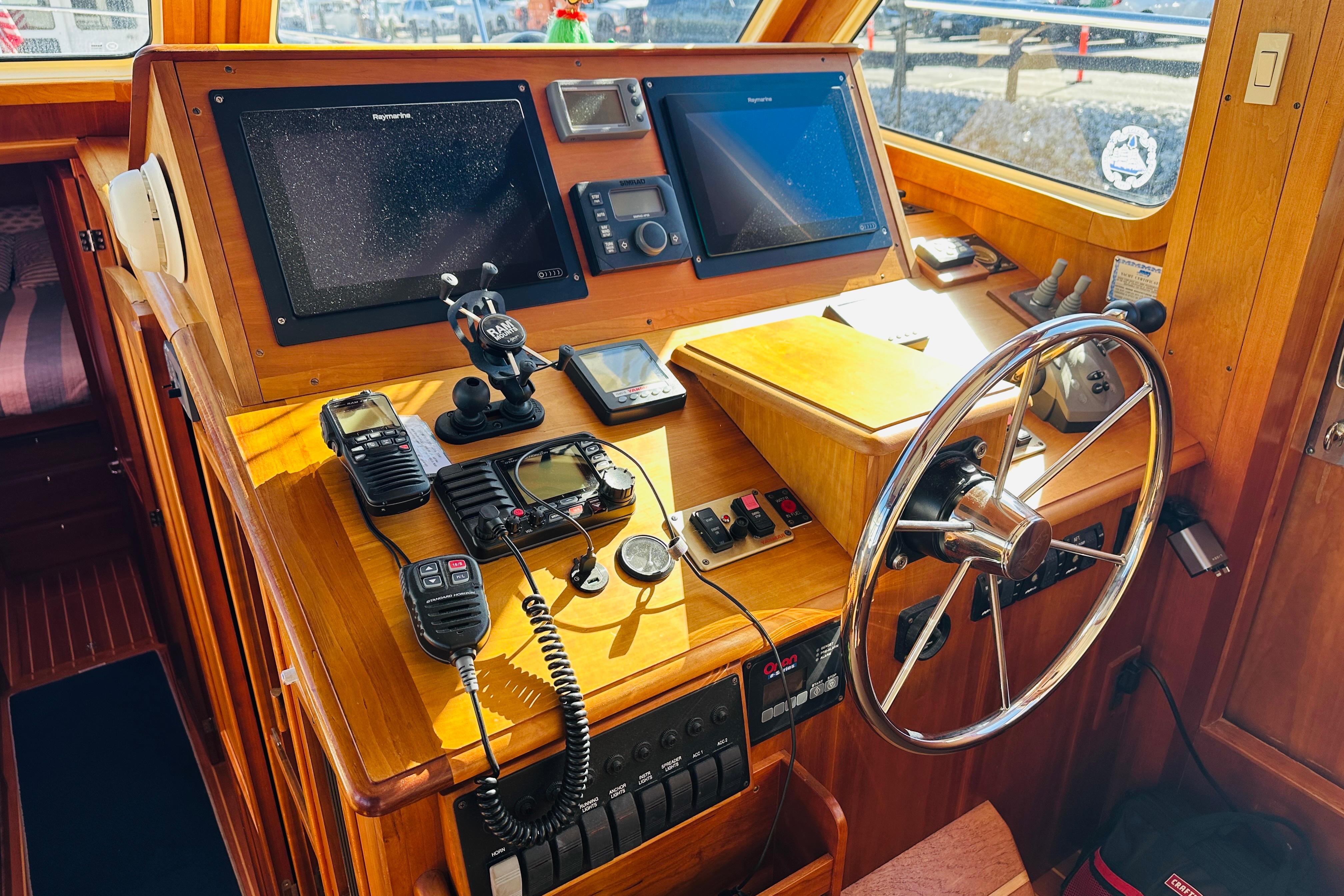 Helm of 2006 Sabre 42 Fly Bridge with navigation equipment and steering wheel.