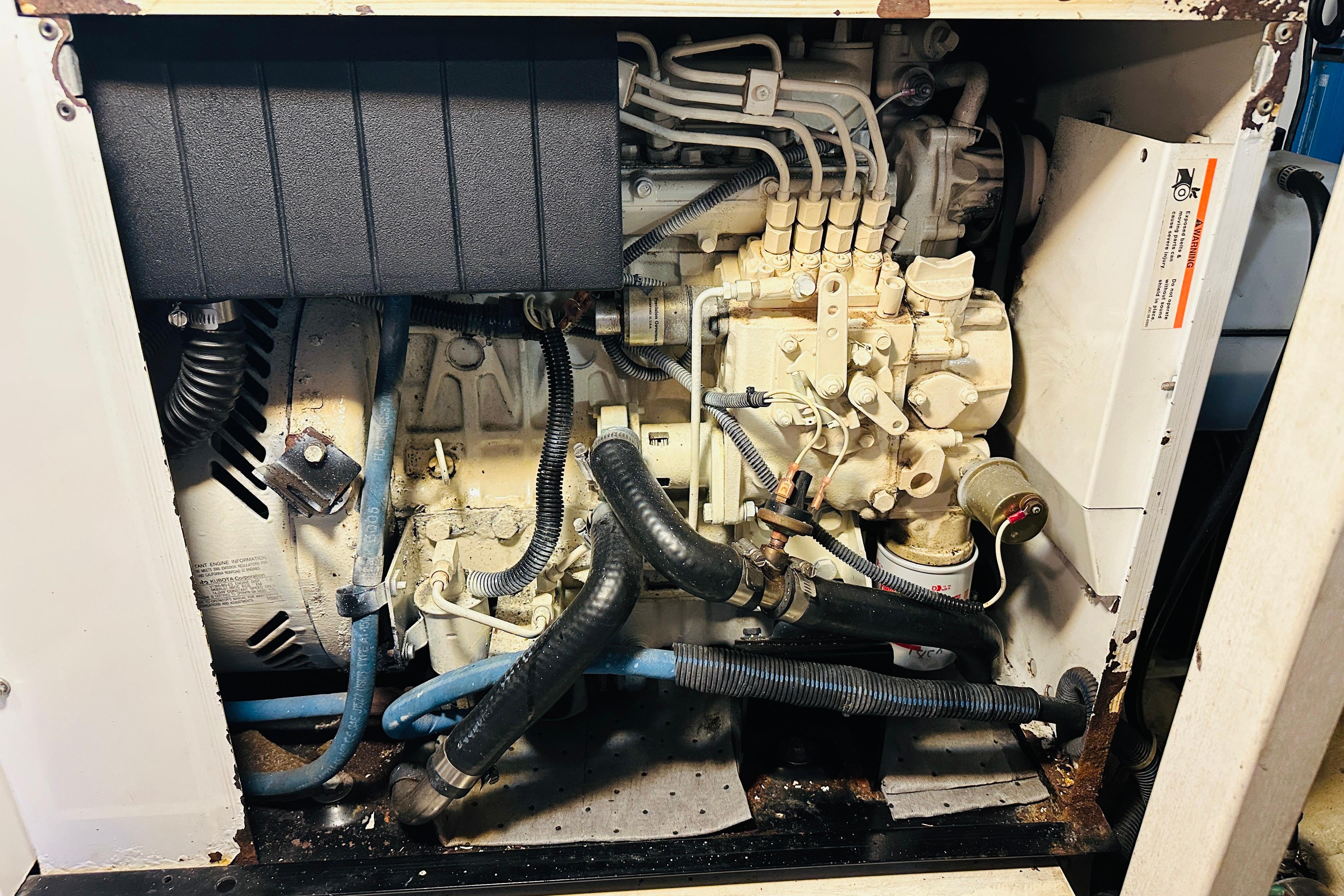 Engine compartment of a 2006 Sabre 42 Fly Bridge, showcasing mechanical components and hoses.