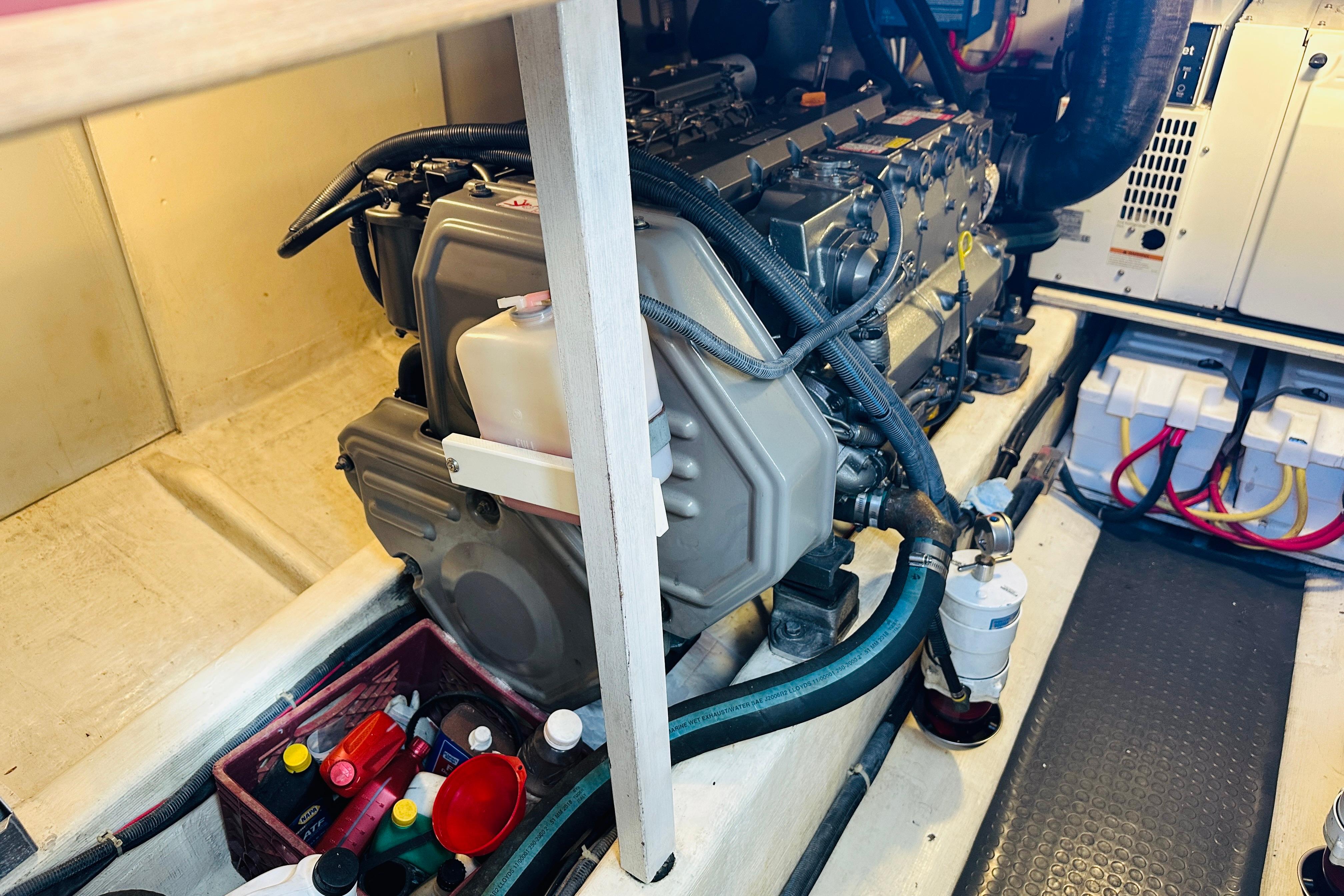 Engine room of 2006 Sabre 42 Fly Bridge with visible components and maintenance supplies.