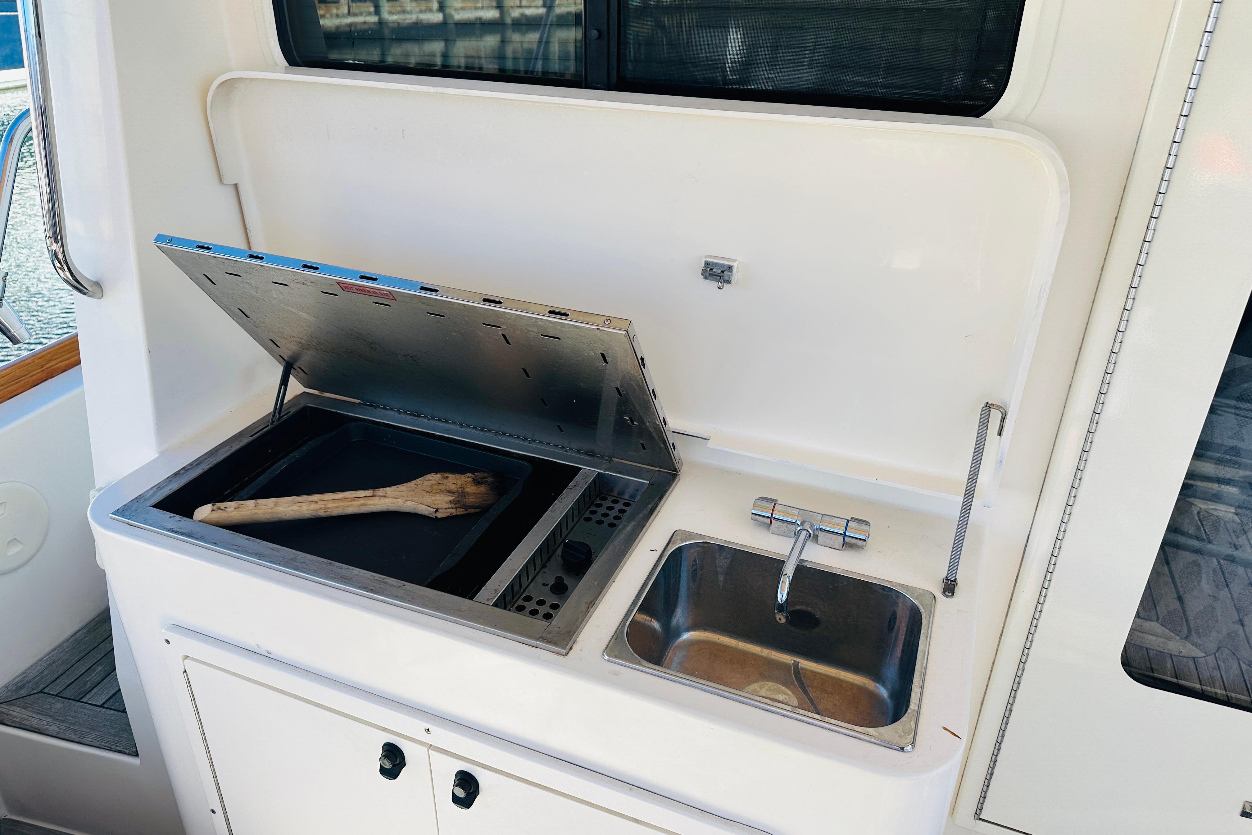 Outdoor sink and grill on 2006 Sabre 42 Fly Bridge yacht.